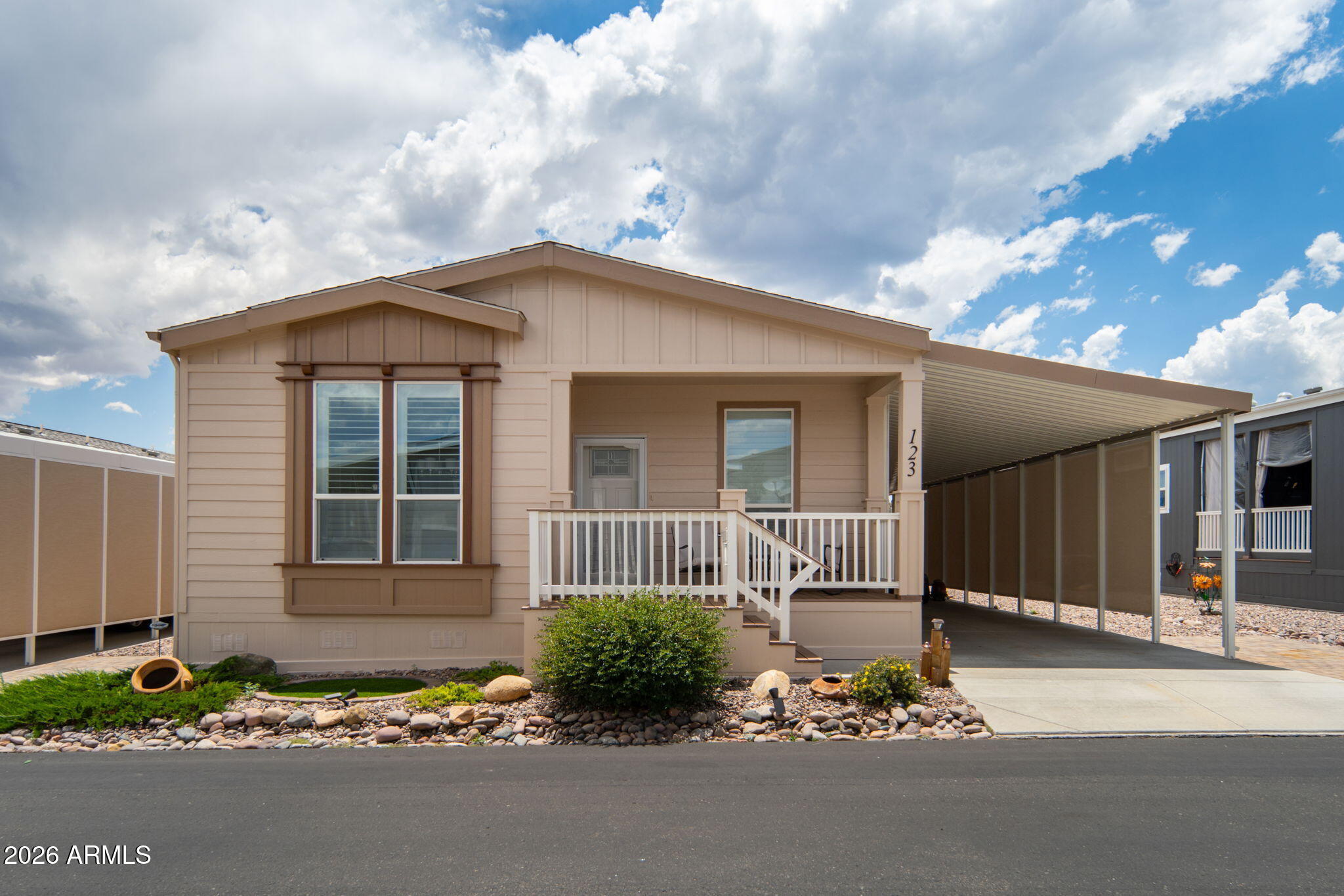 Welcome to this well-maintained 3-bedroom home in the highly desirable 55+ community of Orchard Ranch North. The exterior has just been beautified with a fresh coat of premium long-lasting paint.  The bright, open layout features a modern kitchen with white shaker cabinets, stainless steel appliances, a large island, and a walk-in pantry, seamlessly connecting to the comfortable living space. Plantation shutters, coffered ceilings, and upgraded ceiling fans enhance the home's charm throughout. Two guest bedrooms and a full bath provide versatility for visitors or hobbies. The spacious primary suite includes dual sinks, a walk-in shower, and generous closet space. Enjoy peaceful mountain views and Arizona skies from the covered deck.