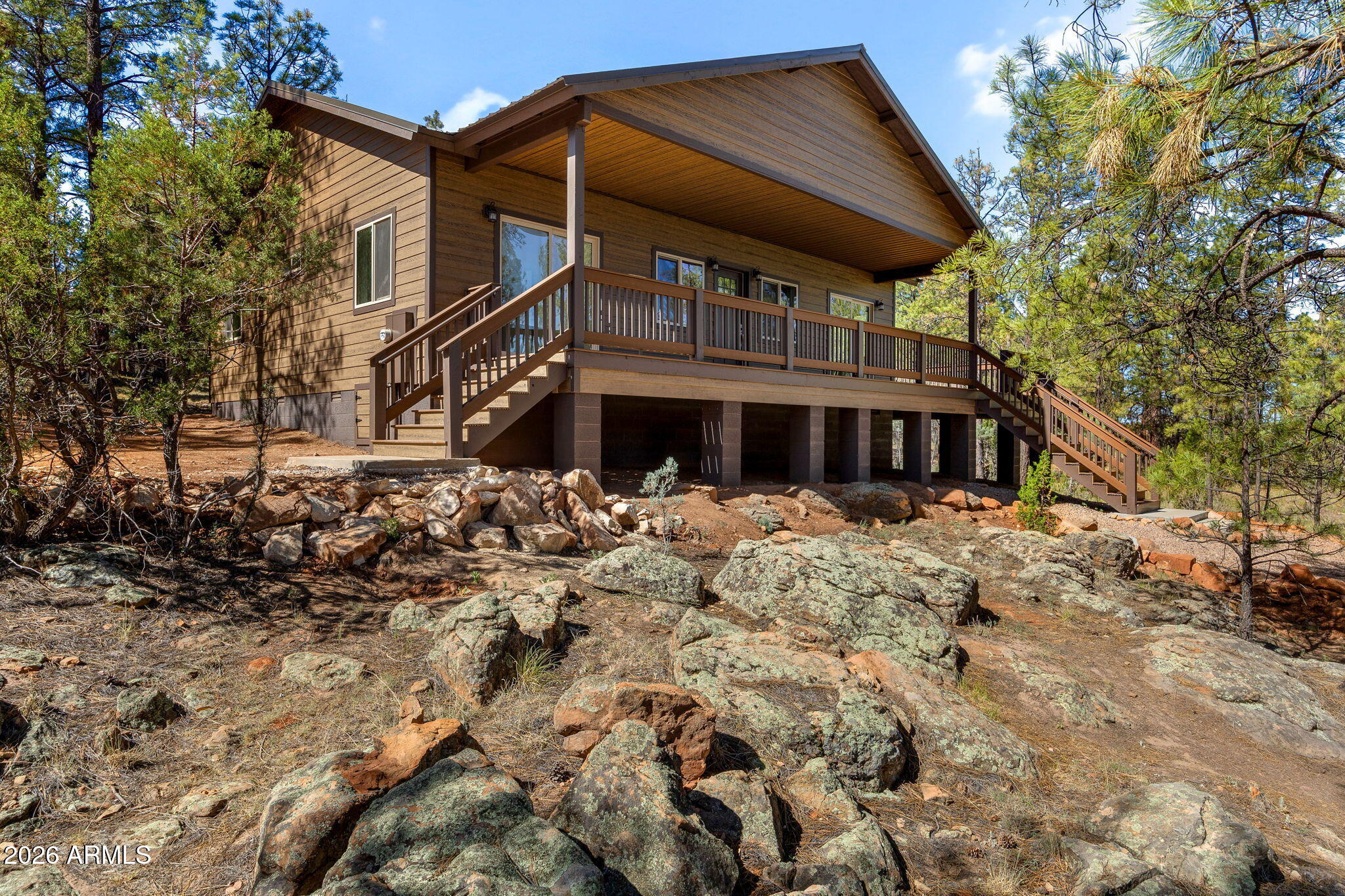 Escape to the cool mountain air in this stunning brand-new single-level cabin, thoughtfully designed with comfort, style, and quality craftsmanship in mind. Tucked among the tall pines, this 3-bedroom, 2-bath home features a desirable split floor plan, offering both privacy and functionality.

Step inside to an inviting open great room with vaulted ceilings, abundant natural light, and beautiful finishes throughout. The spacious kitchen is complete with granite countertops, custom cabinetry, and brand-new major appliances, making it ideal for both everyday living and entertaining. Elegant granite surfaces continue throughout the home, including the beautifully designed bathrooms with custom tiled showers. The primary suite is a true retreat, featuring a large walk-in closet with plenty of natural light, and direct access to the expansive back deck through a walkout slider. A secondary bedroom also offers private deck access, creating the perfect setup for guests or a peaceful home office.

Outside, enjoy the large partially uncovered deck surrounded by towering pines, where you can take in breathtaking sunset and treetop views year-round. Whether relaxing with your morning coffee or hosting friends and family, this outdoor space was designed to capture the beauty of mountain living.

Built with long-term quality and peace of mind in mind, this home includes a 2-year craftsmanship warranty, a 10-year HVAC/heating warranty, 30-year warranties on both the metal roof and smart siding, and a 20-year warranty on the TimberTech decking.

A rare opportunity to own a beautifully crafted new build that combines modern luxury with the serenity of the mountains.