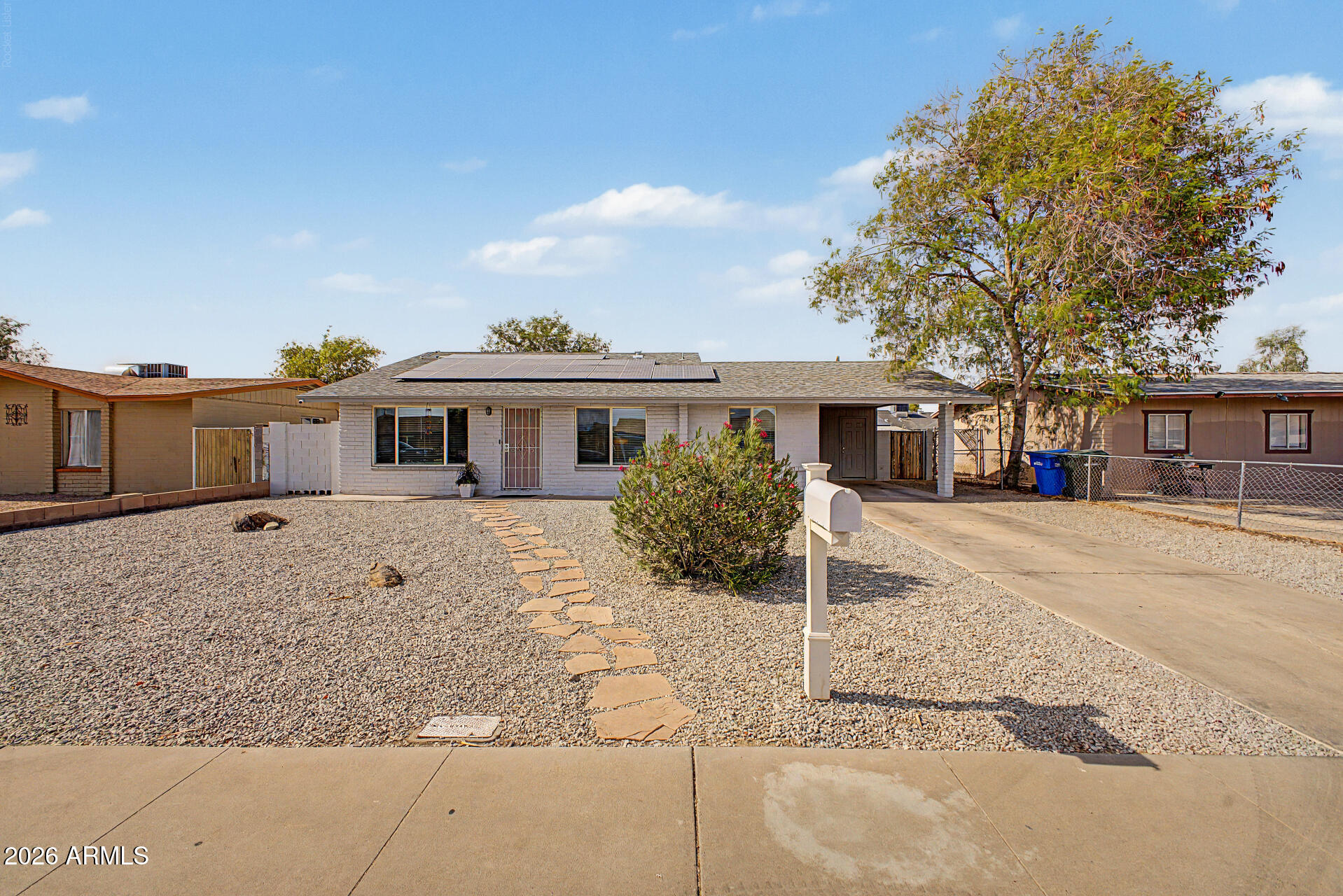 Discover exceptional value in this move-in ready 3-bedroom, 2-bath home featuring a bright and open floor plan designed for comfortable everyday living. The spacious kitchen offers white cabinetry, granite countertops, stainless steel appliances, and ample storage, seamlessly connecting to the main living areas. Wood and tile flooring throughout provide durability and easy maintenance.Enjoy the benefits of leased solar panels to help manage energy costs, along with a covered parking space. Conveniently located near Westgate Entertainment District, Loop 101, State Farm Stadium, shopping, dining, and entertainment, this home combines comfort, style, and an unbeatable location!!!