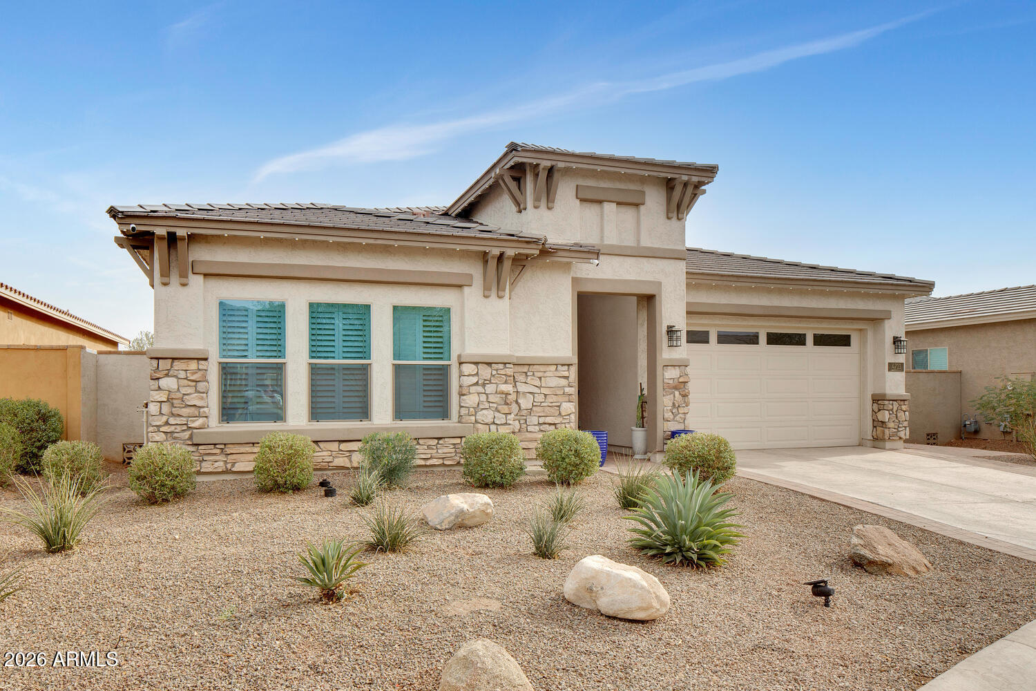 Tucked within the exclusive gated community of Verrado Highlands, this exceptional David Weekley Wonderment model captures the very best of elevated Arizona living. Set on an oversized premium lot, the home offers over $215,000 in upgrades, striking curb appeal, and a resort-style backyard with a sparkling pool and waterfall feature, fire pit, and a gazebo with a BBQ island, where vistas of the White Tank Mountains create an unforgettable experience.
From its beautiful stone-front premium elevation to its thoughtfully curated finishes, this home was designed to impress. A grand rotunda entry opens to expansive, light-filled living spaces with 10-foot ceilings, 8-foot doors, plantation shutters, custom feature walls, and an effortless sense of style throughout. Newly updated TILE in ALL bedrooms! NO more carpet! Designed for both everyday comfort and exceptional entertaining, the open-concept floor plan features 4 bedrooms, a den, sunroom, and 3.5 baths. At the heart of the home, the chef's kitchen shines with a large statement island, navy tile backsplash, upgraded GE Profile appliances, gas cooktop, and reverse osmosis water system.
The indoor-outdoor connection is truly special. A dramatic double-wide sliding glass door opens to a travertine patio and a private backyard oasis with enhanced landscaping, generous entertaining space, a shaded gazebo for outdoor dining and BBQs, and a stunning stone fire pit for evenings under the stars.
The owner's suite is a peaceful retreat with a spa-like bath featuring a soaking tub and a walk-in tiled rain shower. A private ensuite guest bedroom adds flexibility for visitors or multigenerational living, while the 3-car tandem garage offers ample storage and space for a golf cart.
Beyond the home, Verrado offers a lifestyle few communities can match-miles of scenic trails, two championship golf courses, dining and shopping, fitness and pool amenities, and more than 80 parks, all connected by charming tree-lined streets. With top-rated schools, golf-cart convenience, and a vibrant calendar of community events, this is more than a home-it's a lifestyle.