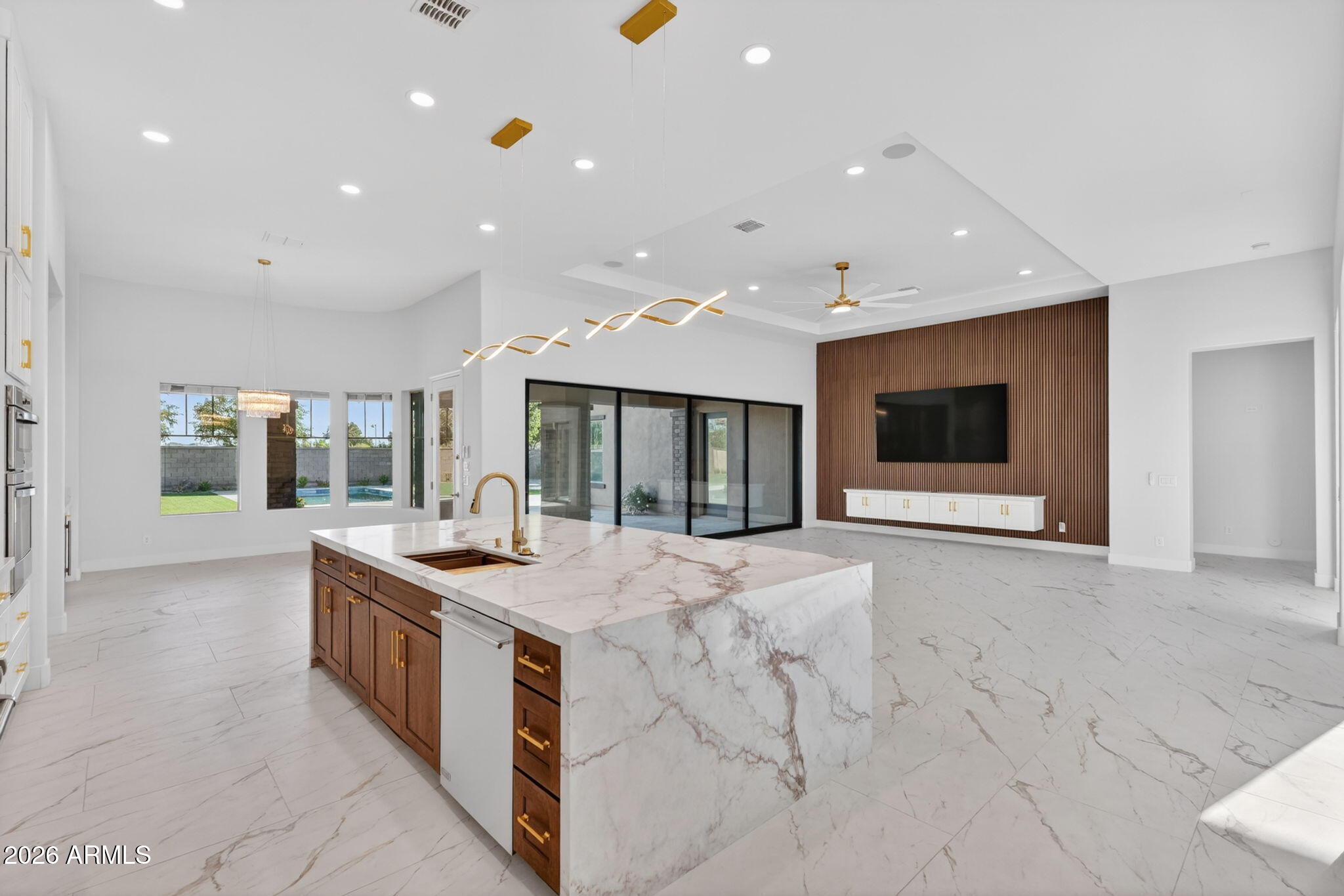 Literally this is like a brand-new home!! This 5,000+sf home was completely gutted down to the drywall and is a high-end remodel!  A new custom pool was added along with a complete yard makeover. Over 1/2 acre of land!  All 5 bedrooms have private baths and walk-in closets (Master and Jr Master plus 3 other bedrooms), plus 2 half baths for a total of 7 bathrooms.  Open concept floor plan at its best!  Massive great room with 12' ceilings and a new 20' arcadia door system - and wow what a kitchen and island!  Great room wall is over 20' long and has a 100' TV with floating cabinets below and wall has warm wood finishes.  There is a separate family room which is centrally located on the east wing of the home by the other three bedrooms and half bath. Split floor plan with master suite located on the west side of the home and it features a 12' bi-fold arcadia door that leads out to the pool and hot tub, there is also a door to the patio.  Master bathroom is a private oasis with a 10'x10' shower with an array of features; separate his and her vanities, toilet room, floating tub with state of the art jets and LED lighting.  Huge walk-in closet and much more.  The Jr Master suite is strategically located on the south end of the home, it's a large in size and it also features its own separate shower and tub. 4 car garage and one bay would make a perfect gym area if so desired. This is an entertainers dream kitchen with a massive island, breakfast bar, and an abundance of counter space, high-end gas cooktop, double ovens, walk-in pantry, separate coffee/wet bar area, and a large breakfast room overlooking the beautiful backyard.  Near the entry is the 5th bedroom which makes a perfect guest bedroom and the nearby entertainment room features a new linear fireplace with triple sliders leading out to a private patio and outdoor fountain - and this room could be a movie theater room or office etc.

Pool was constructed in April 2026 it's heated and it has 6 jets for water features as shown in photos.  The entire backyard redo was also completed in May 2026 and has over 3,000sf of synthetic grass and 1,500+sf of travertine. Pool and hot tub are heated and the there is a gas line stub near hot tub to accommodate any potential future outdoor structure. Exterior of the home was freshly painted in 2025. Large covered and uncovered entertainment backyard areas abound.  

Large grass areas are a blank canvas to make your dreams come true! Various backyard Ramada & Sport court drawings/renditions in photo gallery - check with city and HOA for approvals of what you want to design. 

More remodeling highlights:

The home was gutted down to the drywall, and everything is brand new! 

5th bedroom/bathroom was reconfigured with a full ensuite bathroom, and a 1/2 bath was added off the main entry.  

New 20' arcadia door replaced prior 16' area of sliders in great room.
New 12' bi-fold doors replace prior three windows in master bedroom

Island was redesigned and improved for daily living and entertaining at its best.  All new custom cabinets with upper cabinets soaring to the ceiling, glass doors on upper cabinets. Undermount lighting.  Beautiful appliances, with multiple additional refrigerators. 

Throughout the home all vanities are new, high-end modern gold trim fixtures, and over 10 slabs of quartz were used.  New master and Jr master soaking tubs.  All 5 showers feature custom glass enclosures. 

All new high-end light fixtures, fans, and dacor switches throughout. 

New large format tile and baseboards, all new paint. 

And so much more!!

Legacy at Freeman Farms is an exclusive prestigious gated community with well-manicured homes, wide streets, greenbelts, parks, and tot lots.

Full high-end gut and complete remodel.  Not a fix n flip - during the remodeling process the homeowners simply decided to build a much larger brand-new home on an Acre+ lot that they recently acquired. Extensive info regarding all aspects of the remodeling is available.