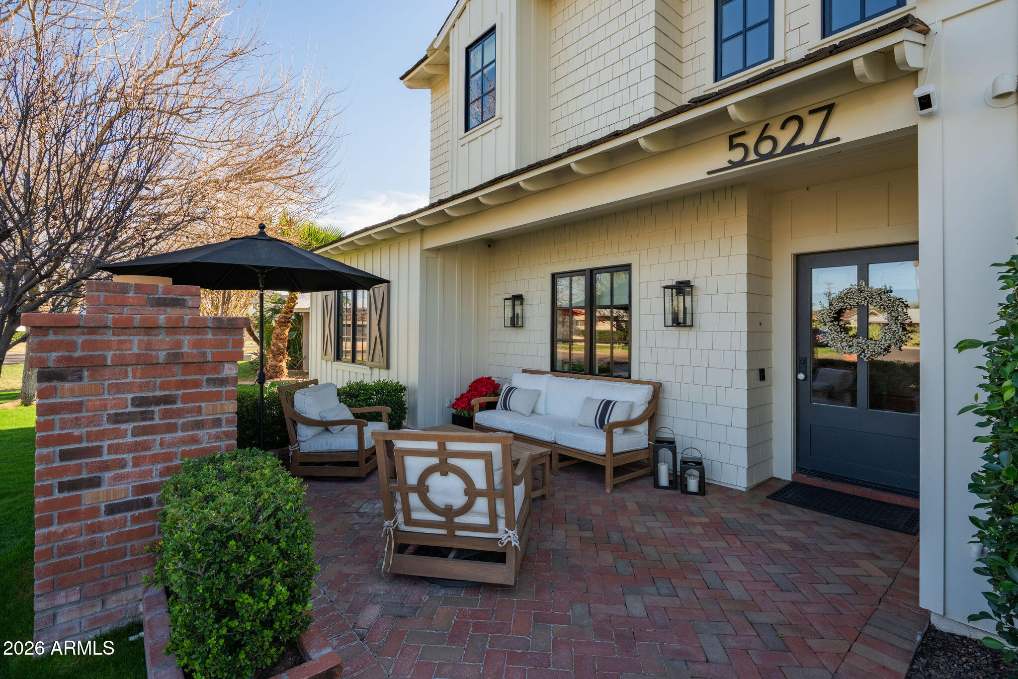 Relax and unwind in this exquisitely designed home, ideally situated in the heart of Arcadia Proper. This stunning 5-bedroom, 3.5-bath home blends timeless craftsmanship with refined modern living, offering exceptional design details at every turn.  Intricate millwork, beautiful wood flooring, and thoughtfully curated finishes create a warm yet sophisticated atmosphere perfect for entertaining friends and family. The chef's kitchen is a true centerpiece, featuring marble countertops, a Thermador range, and an open-concept layout with seamless views into the family room and out to the outdoor gas fireplace. The downstairs primary retreat is a serene sanctuary, complete with a spa-like bath boasting a walk-in shower, elegant clawfoot soaking tub, marble dual vanity, and a generous walk-in closet. A conveniently located stackable washer/dryer, along with a stylish office and charming powder bath, complete the main level. Upstairs, enjoy a spacious game room with its own beverage center, four additional bedrooms, two large dual-vanity bathrooms, and a full-size laundry room ideal for both everyday living and hosting guests. Step outside to discover multiple inviting outdoor living spaces, perfect for Arizona evenings. Enjoy one of two  fireplaces in the front and side yard, cool off in the refreshing pool, or gather around the built-in BBQ and outdoor dining area. Two orange trees add the finishing touch to this quintessential Arcadia backyard.