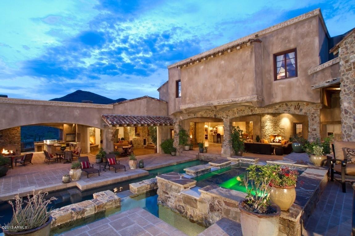 REDUCED $5M!!! Very rare opportunity to own the Magnificent VILLA PARADISO, at an extraordinary price. This European hillside estate is fully loaded with all amenities & located in north Scottsdale's most desirable gated community~Desert Mountain. IT CAN NOT BE REPLICATED AT CURRENT PRICE! This timeless estate has never been lived in-like new with warm inviting spaces featuring expansive views of the city lights, mountains and sunsets; where enchanting walls of glass retract providing seamless indoor outdoor living onto sprawling covered & sun filled verandas. Remarkable finishes of hand-crafted stonework, french oak flooring, 150 year old beams enhance the very private setting nestled on 5 acres & bordering a 3,000 acre nature preserve. NO BETTER BUY IN NORTH SCOTTSDALE! The kitchen is a chef's delight with every imaginable amenity: wood burning pizza oven, 3 country sinks, Miele espresso bar, Viking Steamer, Bravo! Opulent Master Suite with his and her French country vanities, raised Aquatic Bubble Soaking Tub, extravagent multi-nozzeled shower & separate outdoor spa area.  Exquisite library/study is accented with a Scogliola limestone fireplace. You'll never leave the game room with 5 individually controlled flat screen TV's, a handsome wet bar, pool table & putting green.  Impressive 1000 bottle wine cellar located adjacent to formal dining room. The theater offers plush seating for 16, concession stand with popcorn machine, Kaleidescape Entertainment System and finished with surround sound.  There are two ensuite oversized guest rooms on the main floor with an elevator to easily access the upper level spacious guest suite complete with kitchenette, bath and living quarters with separate access to garage & main house. There is an additional 1 bedroom casita with living room, full kitchen and bath, separate entrance & beautiful views from the private balcony. The extensive verandas stretch the entire south side of the home, complete with full outdoor kitchen, dramatic pool, elevated spa & spillover water features.  The 7-car garage can accomodate an additional 5 sports cars by adding lifts. Home automation by Crestron Touch Screen control panel.  Live a fabulous Sonoran Desert Lifestyle with private, world-class golf on six Nicklaus courses, award winning tennis, swim/health facility, 15 miles of hiking and mountain biking trails, equestrian center & dining amenities all at your fingertips.  An Equity Golf Membership to the Desert Mountain Club is included in the purchase price. THE ULTIMATE INVESTMENT OPPORTUNITY~PRICED BELOW BANK APRAISAL!  For membership information and approval, please contact the listing agent.