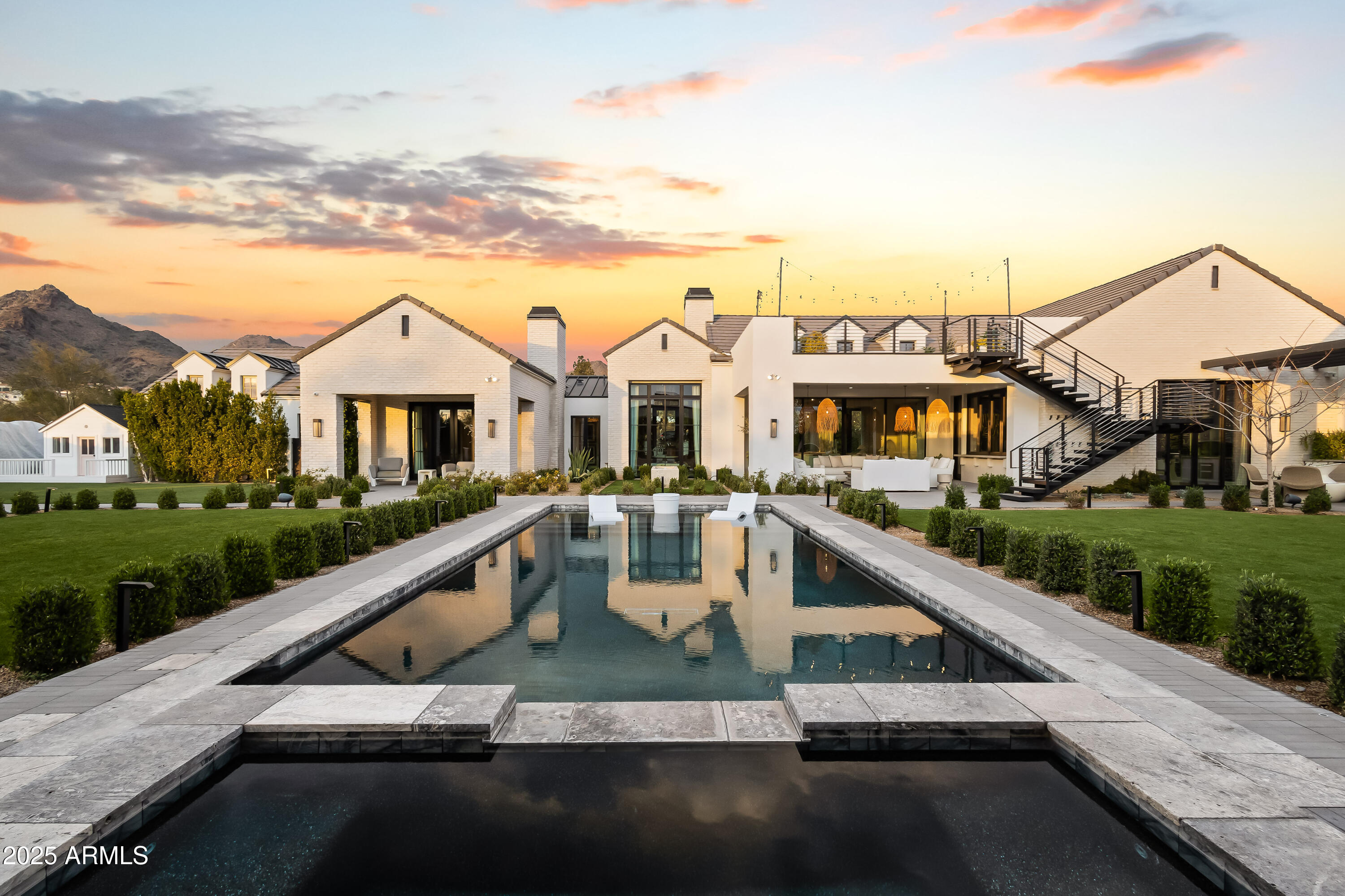 This exquisite custom 2020 estate by Tinker Development, then remodeled by the talented Jaimee Rose, is set on 1.27 acres of lush, Refined Gardens designed and maintained grounds, offering exceptional views from so many spots, including a rooftop deck with sweeping 360 degree views. First cabin craftsmanship throughout, the home features Zellige handmade tile, large format white oak, micro cement, Venetian plaster and Kelly Wearstler wall coverings, custom lighting and resort worthy indoor-outdoor living spaces. All highlighted by multiple fireplaces, negative edge spa, in ground, illuminated pickle ball and expansive indoor outdoor audio for large-scale entertaining. The thoughtful split floor plan ensures both privacy and comfort, while the 5-car garage, 2 motor courts, and a dead end street provides ample space for all your storage and entire entourage. A true entertainer's dream, this home seamlessly combines luxury, design, and functionality for an unparalleled lifestyle. Lastly an in ground trampoline and a child's custom playhouse with AC makes this a dream getaway for the entire family.