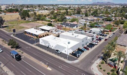Location, Location, Location!!! Ideal opportunity for an owner/user investment property located at 1890 East Indian School Road (aka 4108 N 19th Street) including 4112 N 19th  Street as additional parking, well suited for a number of uses. This property boasts a 15280 sq ft building with ~ 6080 sq ft Office 1000 sq ft of useable Loft and 8200sq ft storage, 27,800 + SF lot with a fenced and gated yard and upgraded offices, consistently and well maintained by the current owner. Price includes additional parking next door (parcel 163-29-073). Only seconds from SR 51 with Indian School Frontage, this strategically located property is perfect for either investors or owner/user. Just a block from the 51 highway, with access from either Indian School Road or 19th St, this property ... is both highly visible as well as accessible. With ample parking, multiple roll-up doors, a secured yard space and C2 Zoning, it offers the potential for a variety of commercial uses as well as a terrific investment opportunity. There is a current lease in place until July 30, 2026, providing a short term income stream. Priced at $2,700,000.00, this property is poised to increase in value as the Metropolitan Phoenix area continues to benefit from an increasing population and a variety of new business ventures. Centrally located with access to all parts of the valley, it offers a tremendous opportunity. Seller will carry with 20% down, 10% interest only up to five years, no prepayment penalty. 

KEY POINTS
" OWNER/USER INVESTMENT OPPORTUNITY
" FRONTAGE ON HIGH TRAFFIC INDIAN SCHOOL ROAD 
" LOCATED LESS THAN A BLOCK FROM THE 51 HIGHWAY 
" EAST AND WEST ACCESS OFF INDIAN SCHOOL ROAD
" AMPLE PARKING
" ROLL-UP DOORS & FENCED YARD
" TENANT LEASE IN PLACE UNTIL JULY 30, 2026
" SELLER FINANCING 

BASE INFORMATION
ASKING PRICE: $2,700,000
LAND AREA: 0.64 ACRES
BUILDING AREA: 15,280 SF
ZONING: C-2
APN: 163-29-075B & 163-29-073
