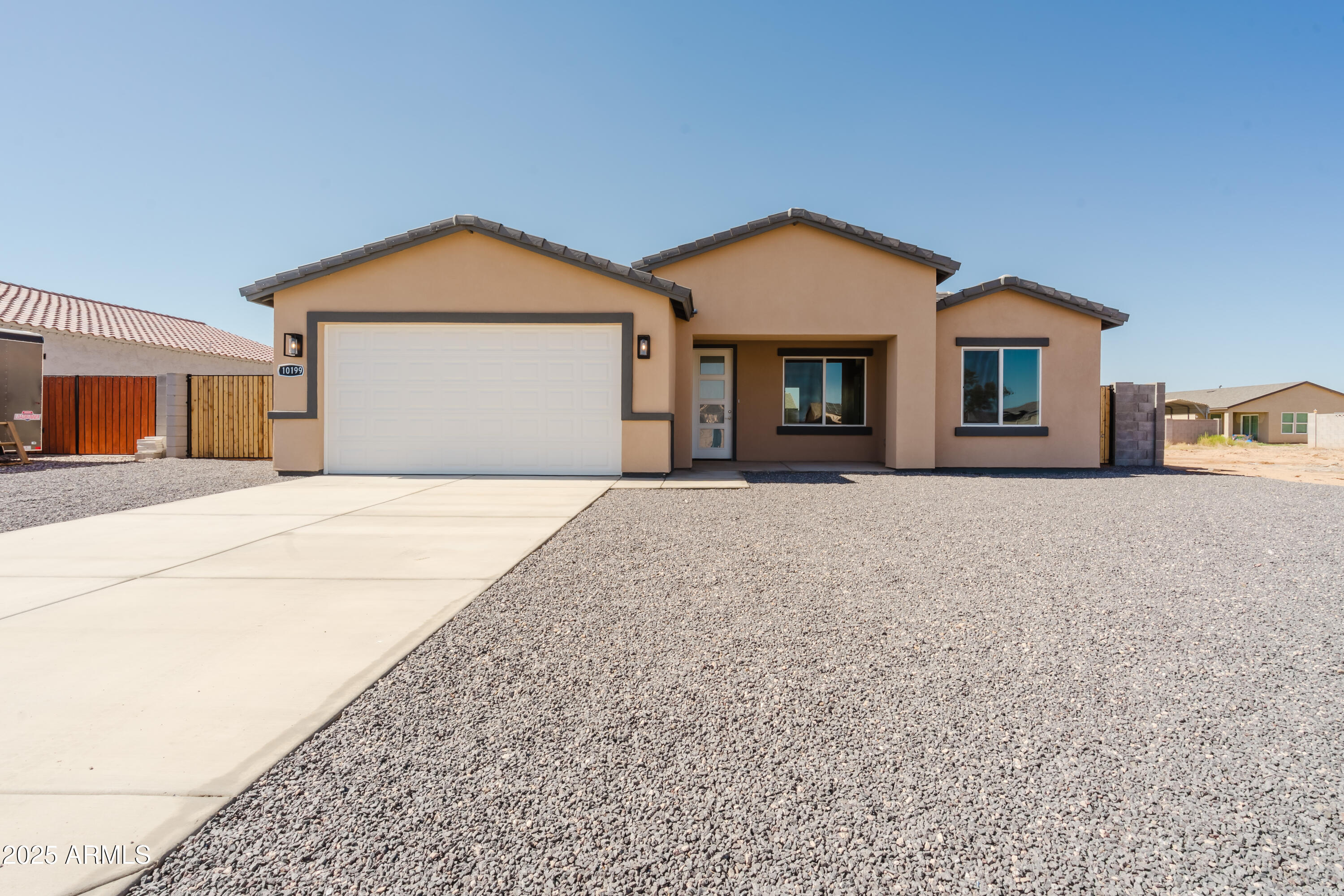 Welcome to 10199 W Bradshaw Drive, a brand-new 4-bedroom, 2-bath home in the heart of Arizona City—one of the area's fastest-growing communities! Here, you'll find no HOA, a spacious open floor plan, and high-end finishes throughout. Enjoy granite countertops, designer tile floors, cozy carpeted bedrooms, and a kitchen complete with stainless steel appliances including, microwave, dishwasher, fridge and stove. Whether you're looking for a beautiful home or a property in a rapidly developing area, this home checks every box.