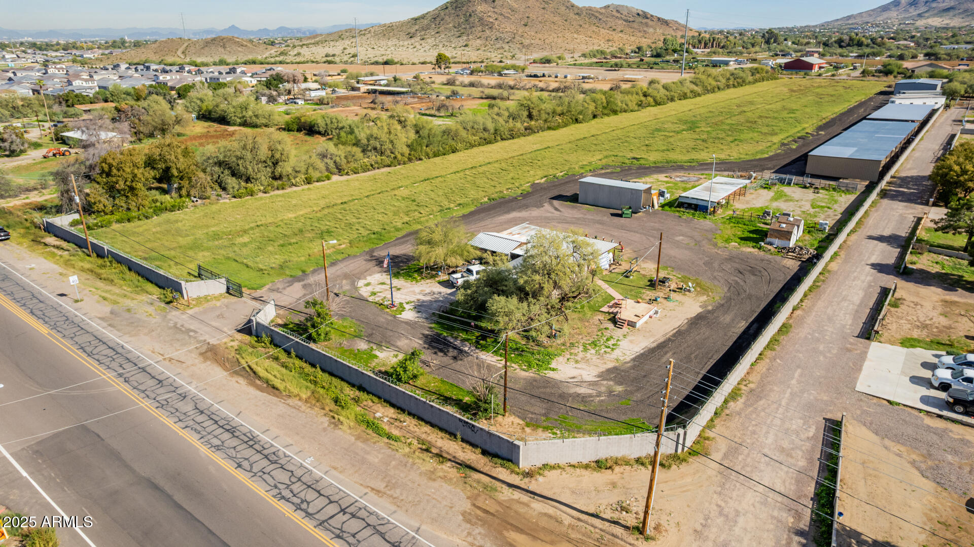 This is a fabulous investment property with 2 contiguous parcels for a total of 9.672 acres, county island. AND OWNER MAY CARRY TO A QUALIFIED BUYER! Frontage on 51st Ave. Subject lot has a small older livable home. The extra parcel is 300-08-013A and will not be sold separately. The combined parcels have a newer huge metal barn (50x80) with double doors. Approximately 20 covered parking stalls, several sheds and is on one big rectangular lot, close to level with irrigation. This is a booming area of Laveen with tremendous investment potential.