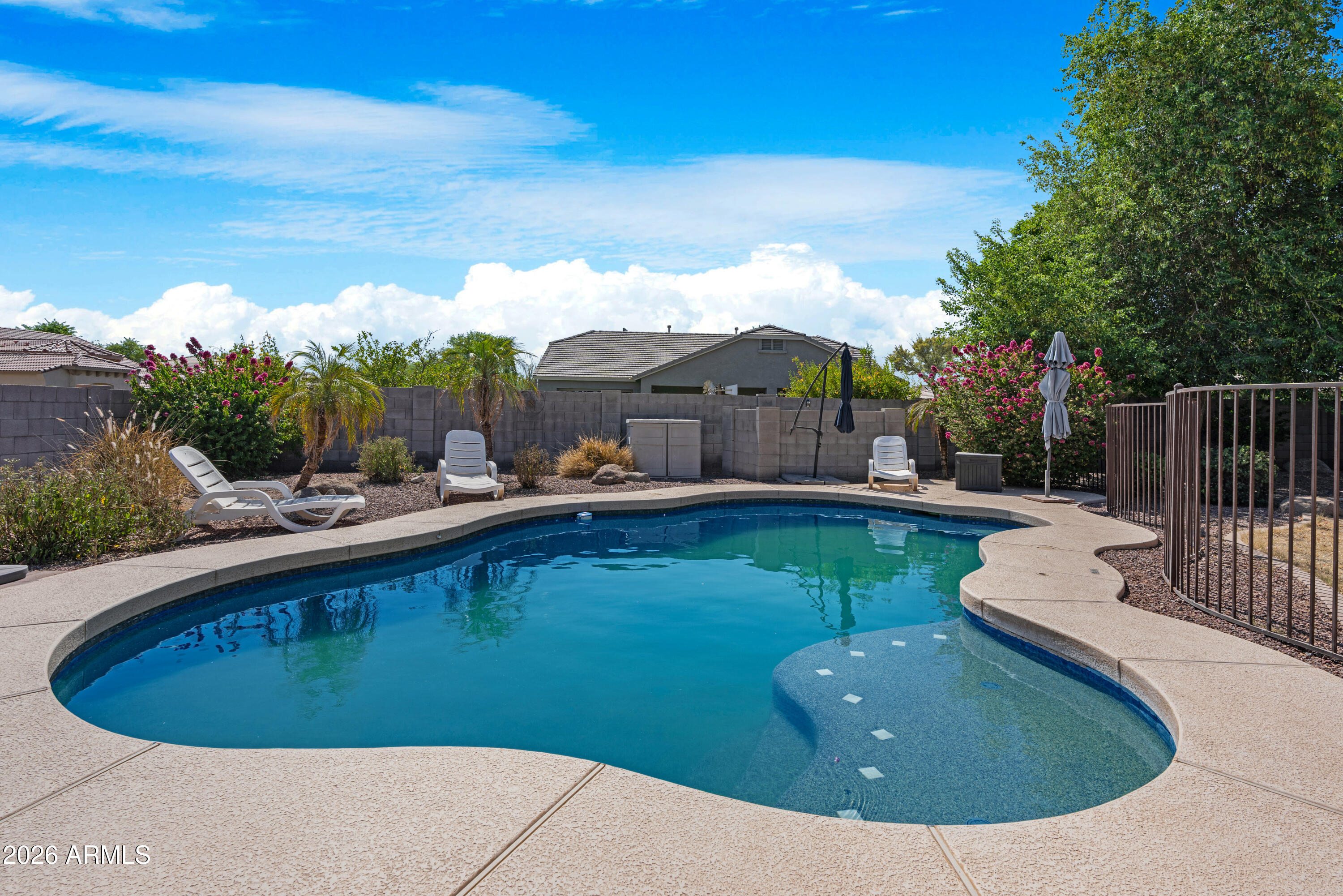 SOLAR WILL BE PAID OFF IN FULL AT CLOSE OF ESCROW! That's a huge savings and one less expense to worry about from day one. With the right offer, sellers are also willing to paint the living room and kitchen prior to closing, giving buyers a fresh start and added value. Located in the gated community of Dreaming Summit, this rare Arizona basement home offers a 3-car garage, RV gate, pool, and flexible living space. The kitchen features custom cabinetry, granite countertops, and ample storage. The spacious primary suite includes a sitting area and spa-like bath. Downstairs, you'll find a large basement living area, 2 bedrooms, and a full bath perfect for guests, teens, or multi-gen living.