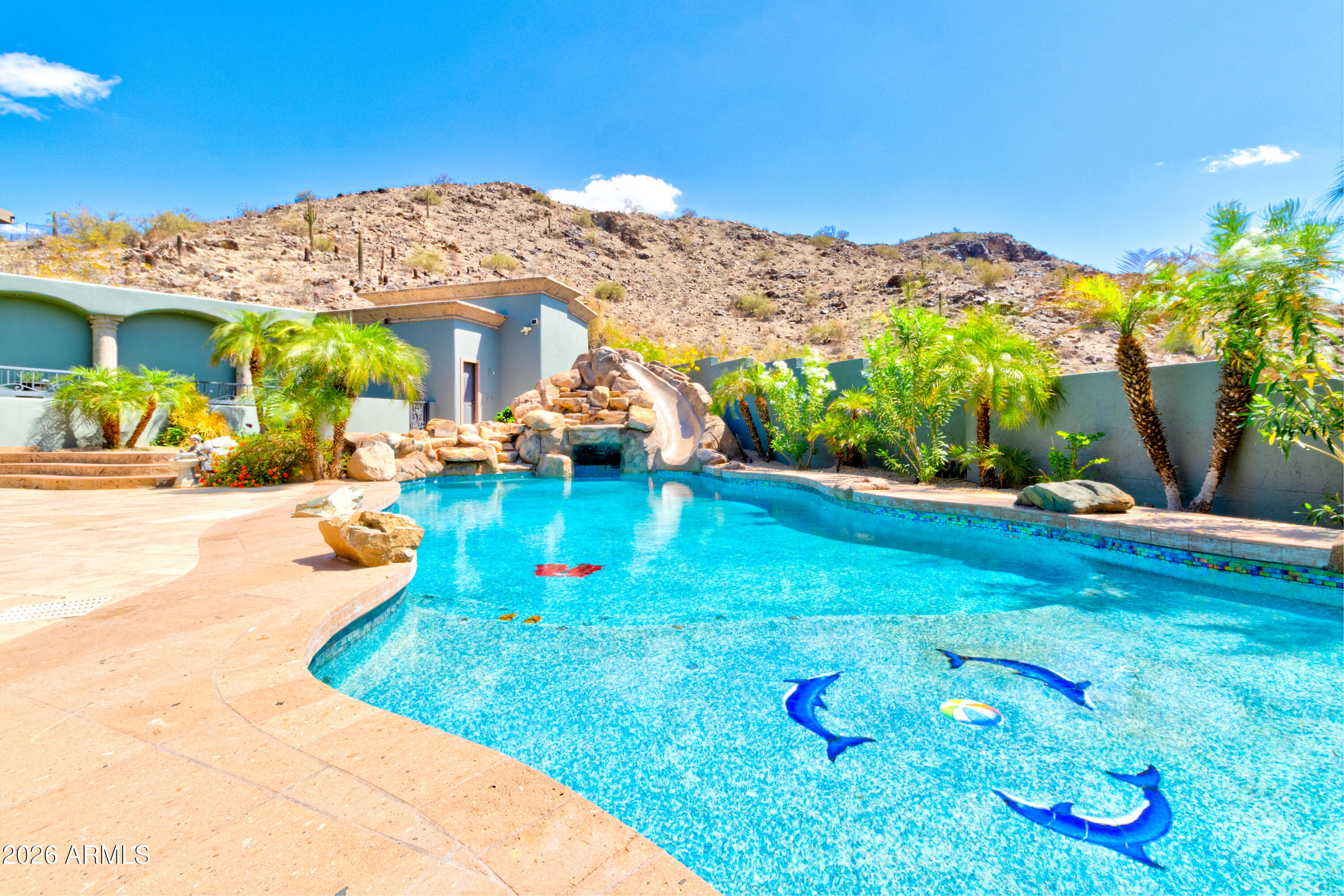 Located in the prestigious gated community of Canyon Reserve, this custom luxury home features ICF construction (solid concrete, wrapped in insulation) for exceptional efficiency and durability. Designed for indoor-outdoor living, enjoy a resort-style backyard with pool, waterfall, grotto, and slide, plus expansive covered patios and a full outdoor kitchen. The home offers multiple ensuite bedrooms, a private casita with kitchenette, game room with balcony, theater with snack bar, and a versatile lower-level flex space. A rooftop deck captures mountain views, and an in-home elevator adds everyday convenience. Exceptional design, quality, and lifestyle throughout. This custom luxury residence blends thoughtful design, quality construction, and exceptional indoor-outdoor living.

A grand entry opens to formal living and dining spaces, leading into a spacious great room and a well-appointed kitchen designed for both everyday living and entertaining. Rich finishes, custom cabinetry, and quality materials are carried throughout the home.

The flexible floor plan includes multiple ensuite bedrooms, offering comfort and privacy for family and guests alike. A standout space functions as a bedroom, library, or home office, complete with custom built-ins and its own private bath. The primary suite provides a true retreat, while additional bedrooms include both private ensuites and a thoughtfully designed Jack & Jill layout.

The game room serves as a central gathering space, featuring a built-in bar and direct access to a private balcony with mountain views--perfect for relaxing or entertaining. A dedicated home theater with tiered seating and a snack bar creates a true cinema experience.

Outdoor living is where this home truly shines. The resort-style backyard features a pool with waterfall, grotto, and slide, surrounded by expansive patios designed for entertaining. A full outdoor kitchen, covered dining areas, and multiple seating spaces create a seamless indoor-outdoor lifestyle ideal for Arizona living.

A detached casita offers a private retreat for guests, complete with its own entrance, kitchenette, and full bathroom--ideal for extended stays or multi-generational living.

Additional features include a rooftop deck capturing sweeping mountain views, a lower-level flex space ideal for a gym, studio, home business, or hobby area, and an in-home elevator connecting the garage level to the main living area for added everyday convenience.

From its versatile layout to its resort-style amenities, this home offers a rare combination of luxury, functionality, and lifestyle.