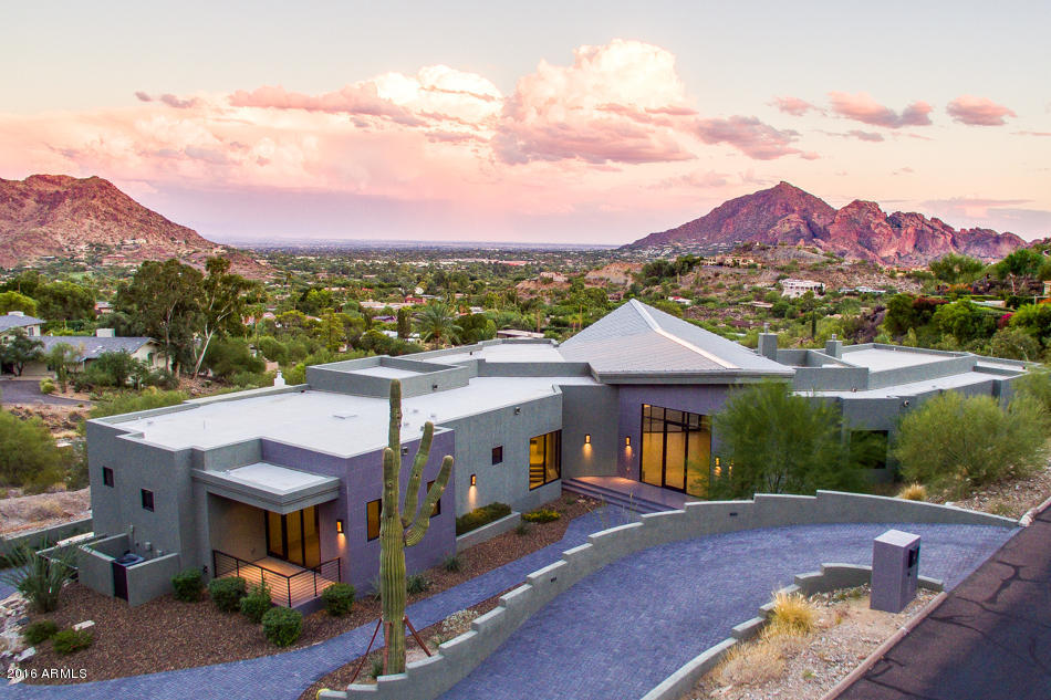 BRAND NEW: Architectural Contemporary. Inside the secure guarded gate of Clearwater Hills with views across Paradise Valley to the Superstition Mountains. The masterpiece Kitchen is sleek & inspiring with touches of glass & stainless steel, plus a casual dining space overlooking the expansive patio & pool area. Formal Dining Room with striking views. Elegant Master Bedroom retreat includes a Study or Gym, & a Master Bathroom with a relaxing spa bath & huge steam shower, all with views. 4 huge en-suite guest bedrooms, with views. A separate Media Room/Playroom or Guest Room with full kitchen & bath. 450 plus BOTTLE Temperature controlled Glass Wine Wall, built in BBQ, negative edge infinity pool & spa are just a few of the amenities that make this an architectural masterpiece. 4 CAR GARAGE.