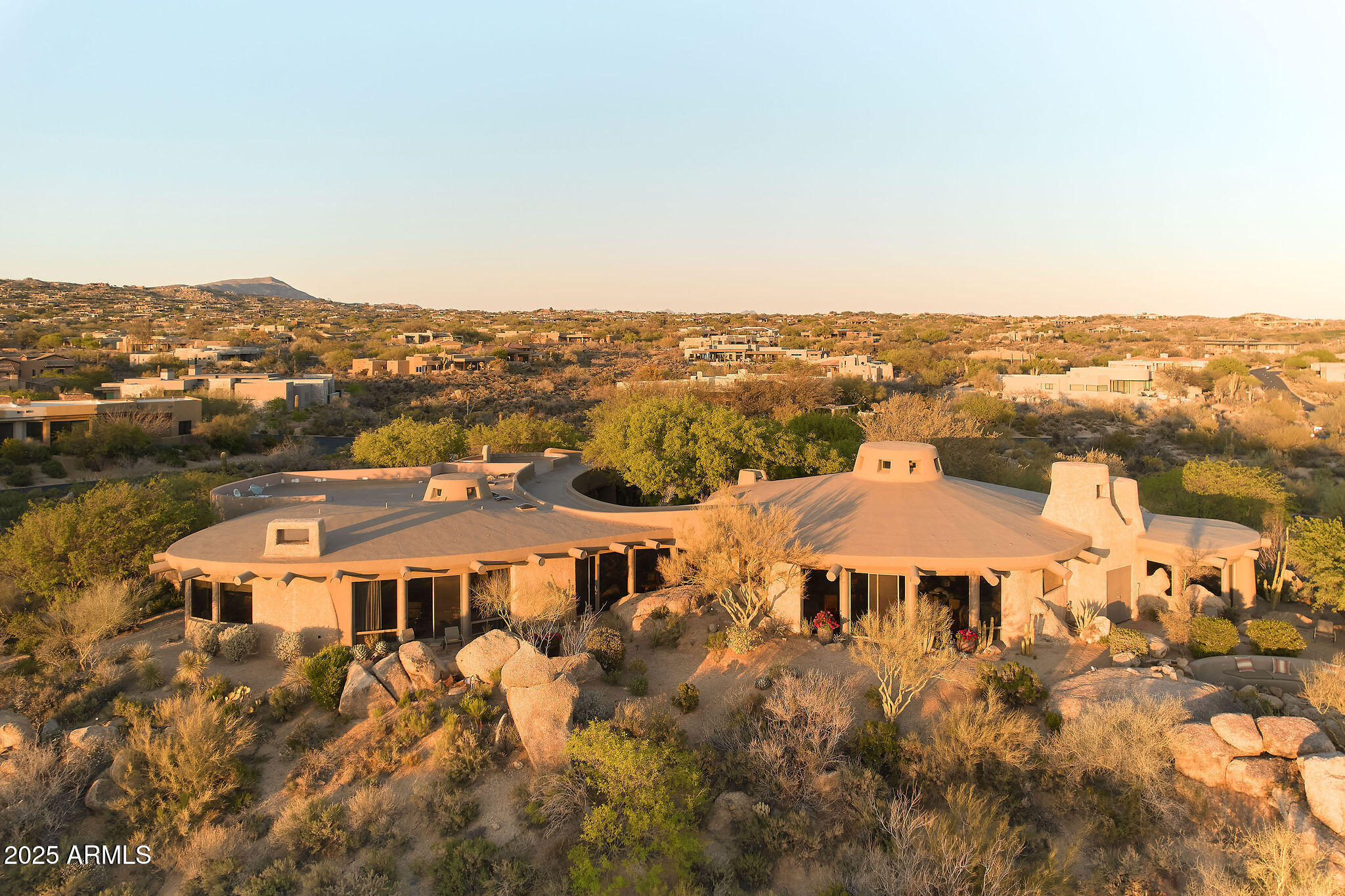 ***$1.5M PRICE REDUCTION - MOTIVATED TO SELL THIS SEASON!!!*** Architect Ron Brissette, former student of Frank Lloyd Wright captured Southwest magic when he created ''Las Rocas.'' Situated on 3 lots spanning 1.8 acres, gorgeous views of the Cochise golf course and city skyline generously lend their beauty. The 5,704 sqft main home is an entertainer's dream while the 1,280 sqft 2 bedroom casita is well-suited for multi-generational living or guests. The main living area features a dome skylight that allows the sun to gently land upon the strong granite boulders. Mahogany doors and Vigas & Latillas hemlock beams compliment the natural elements beautifully. Stunning outdoor landscape was designed by award-winner Donna Winters of Enchanted Garden Landscape. In addition, this home offers a rare opportunity to enjoy a Desert Mountain Lifestyle membership. Lifestyle Membership available to be purchased with this property. The transfer of the Membership requires the submittal of a Membership Application by the Buyer, which must be approved by the Desert Mountain Club's Board of Directors through a process that takes approximately thirty (30) days. Please reach out to Membership Sales at the Desert Mountain Club for details.