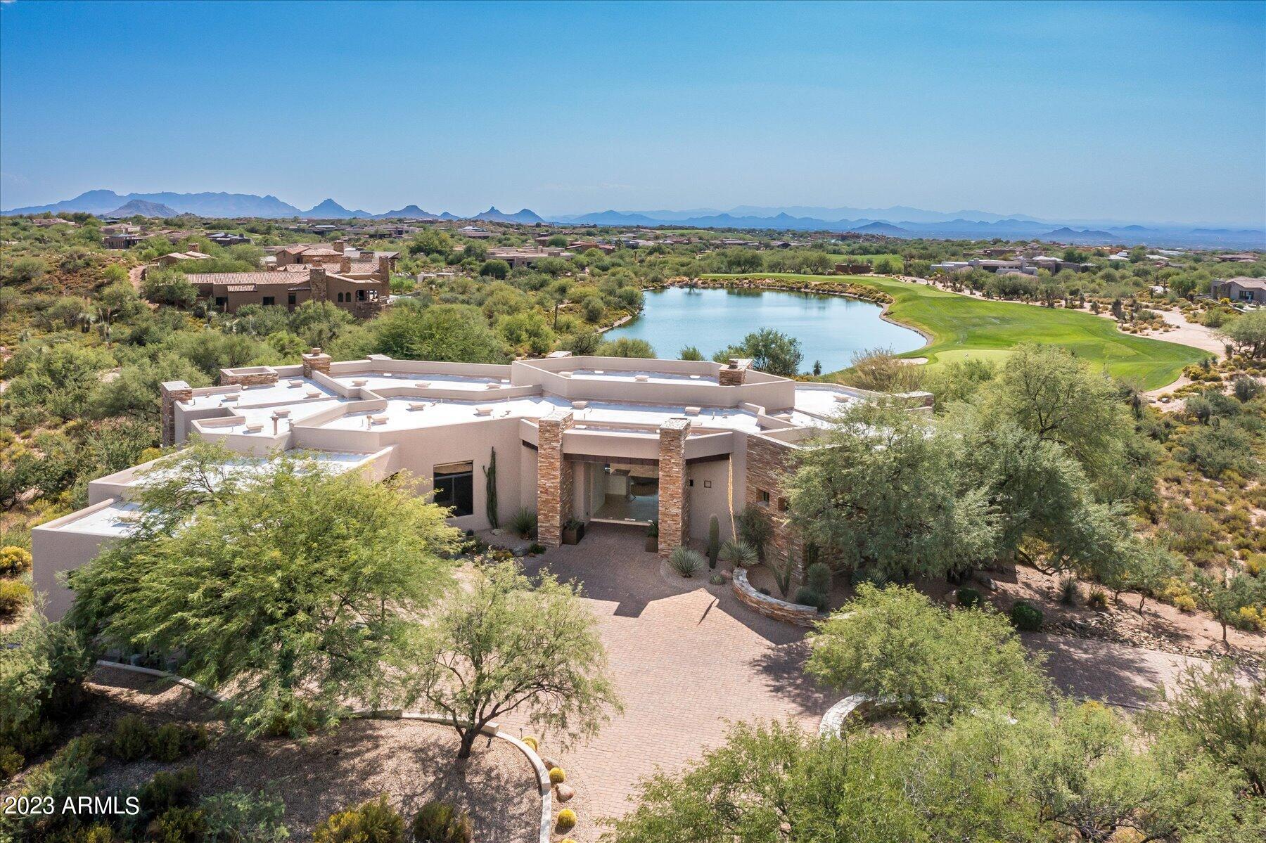 Stunning location on the 15 par 3 hole of Apache Golf Course in Desert Mountain .  You feel like you are on your own island, Private and Spacious! Furnishings included & Golf membership available. Home was updated with new kitchen and baths. Lots of windows and glass and is very light and bright. 4 bedroom en-suites and half bath. Separate living, dining and wet bar. with slider doors to access to outdoor patio. Kitchen, breakfast nook,island , family room and access to outdoor patio. Oversized 3 car garage and plenty of room if looking to expand. The outside has a negative edge pool /spa, overlooking  the lake and the par 3 green.  This lot is 1.6 acres and has plenty of room to add either a casita or multiple garages .  Down valley city light views,sunsets & perfect southwest orientatio Downvalley city light views, sunsets, and perfect south west orientatio