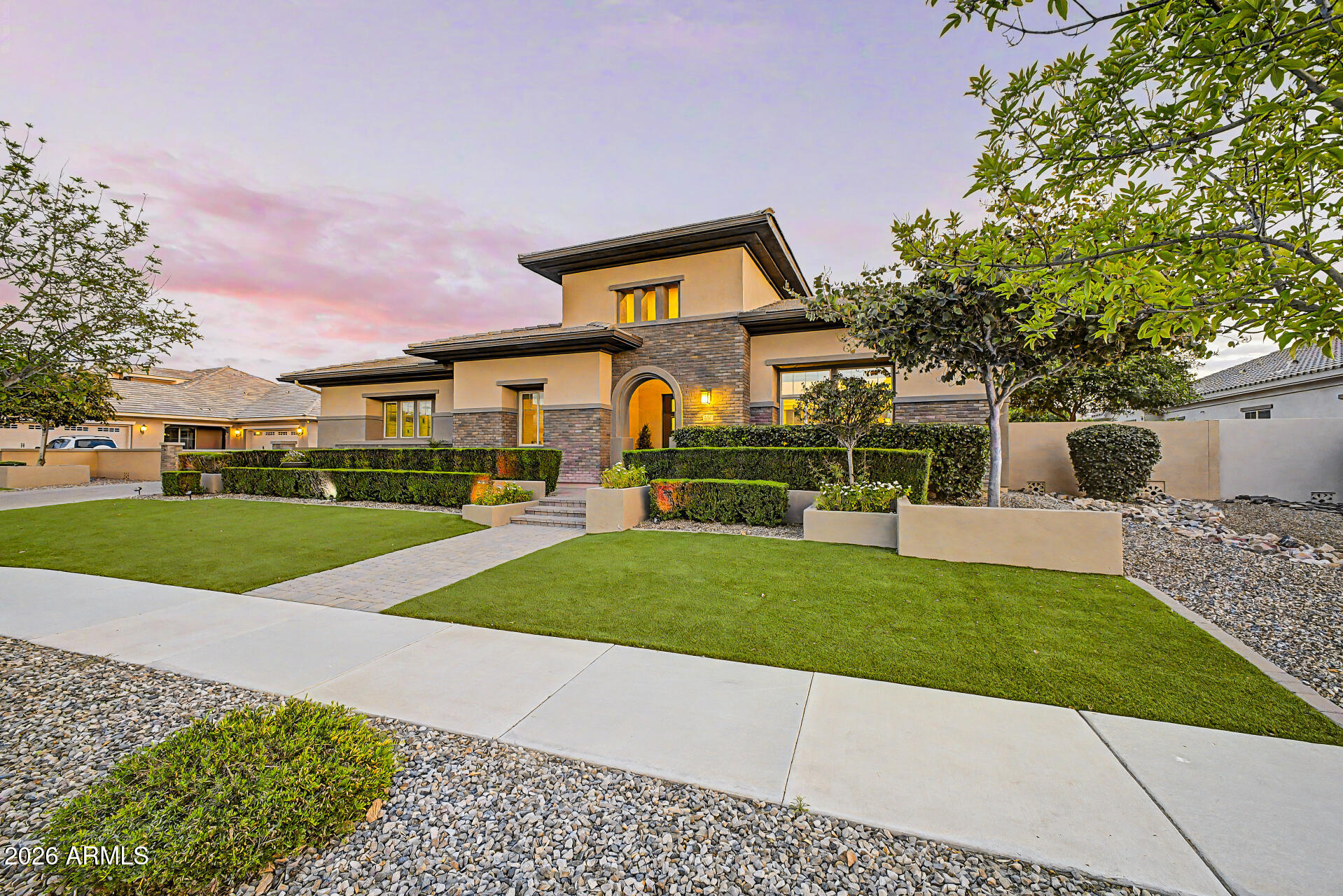 Experience elevated Arizona living in this exceptional single-level luxury residence located in the highly sought-after Freeman Farms community. Built in 2015, this beautifully designed home offers over 5,000 square feet of sophisticated living space with 5 spacious bedrooms, 6.5 bathrooms, and premium finishes throughout. From the moment you enter, you're greeted by elegant tile flooring, tray ceilings with LED lighting, designer fixtures, and expansive open-concept living spaces ideal for both entertaining and everyday comfort. The gourmet chef's kitchen features high-end stainless steel appliances, a walk-in pantry, oversized island, and seamless flow into the great room complete with surround sound and a cozy fireplace. The luxurious primary suite is a true retreat, featuring a . . . lavish bathroom and an oversized walk-in closet. Each secondary bedroom includes its own en-suite bath, offering comfort and privacy for family and guests alike. Step outside to your private resort-style backyard situated on nearly half an acre, featuring a sparkling pool, covered patio with built-in speakers, lush artificial turf, and plenty of room to relax or entertain year-round. Property Highlights: 5 Bedrooms | 6.5 Bathrooms, 5,032 Sq Ft, 0.48 Acre Lot, 4-Car Garage, Single-Level Luxury Home, Gourmet Chef's Kitchen, Resort-Style Backyard with Pool, Dual Fireplaces, Surround Sound, Located in Prestigious Freeman Farms, Top-Rated Chandler Unified Schools Nearby. This home combines timeless elegance, modern upgrades, and premier Gilbert living in one extraordinary package.