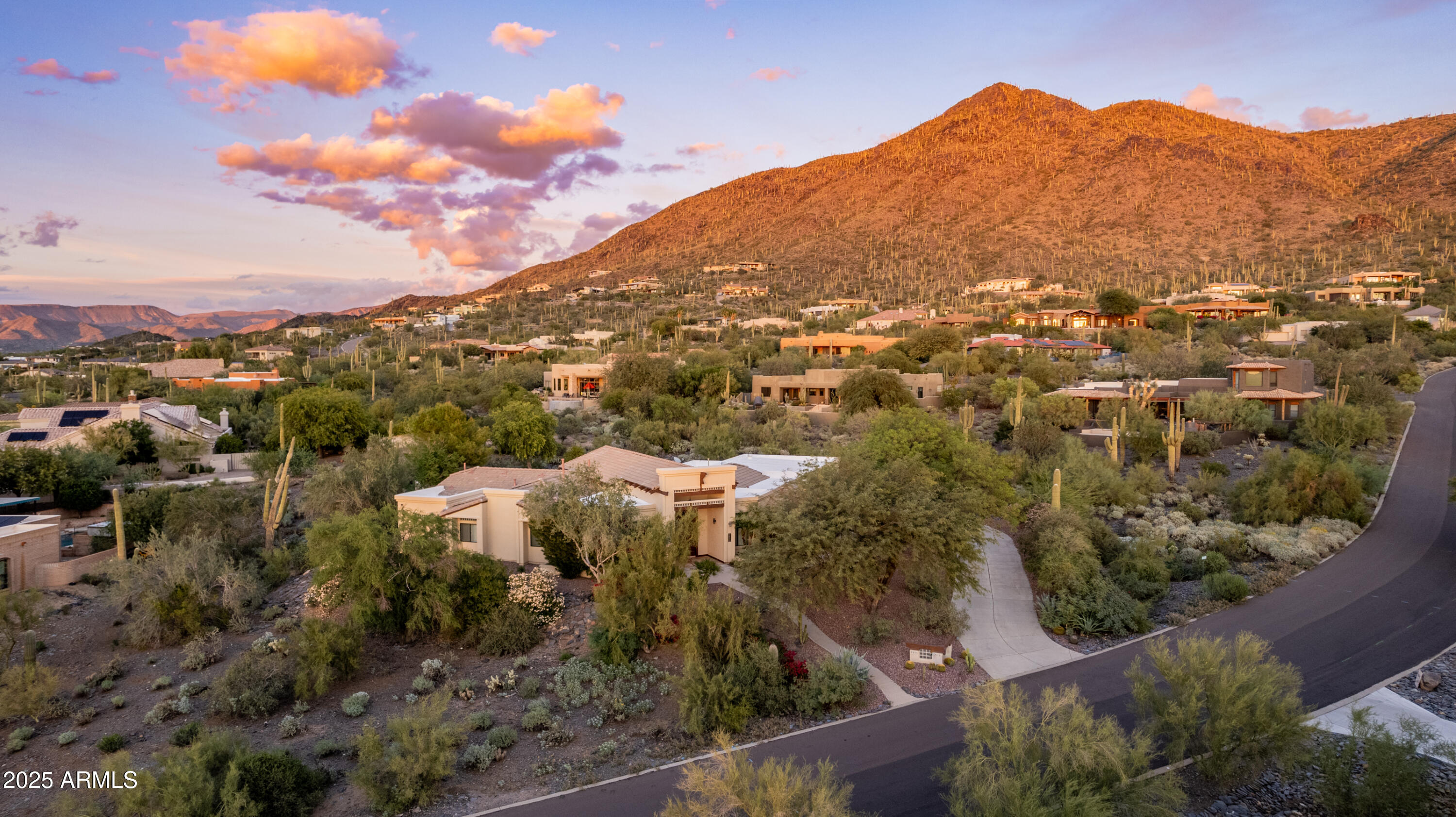 Welcome to your private desert sanctuary in the heart of Carefree. Set on nearly an acre in the prestigious Sentinel Rock Estates, this distinguished 4 bedroom, 3 bath Southwestern Territorial home showcases sweeping Black Mountain views from one of the community's most secluded and sought-after lots.

Architectural detailing, soaring ceilings, and an open concept kitchen and great room create bright, versatile spaces designed for both relaxation and entertaining. The backyard lives like a resort with a saltwater pool, fireplace, built-in BBQ cabana, and expansive covered patios perfect for enjoying spectacular Arizona sunrises and sunsets.

The floor plan includes a private entrance suite ideal for guests, clients, multi-generational living, or a dedicated home office. Additional highlights include a roof replacement completed in 2022 and a three car garage offering generous storage.

Just minutes from shopping, dining, and galleries in downtown Carefree, yet worlds away in peace and privacy, this home embodies the balance of elegance, comfort, and desert tranquility that defines the Carefree lifestyle.