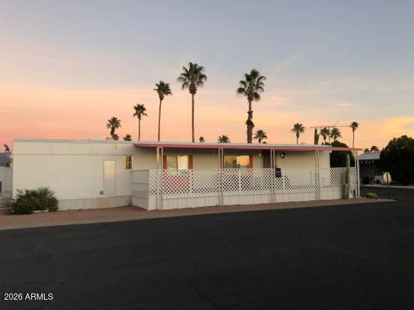 *Seller to paint exterior - color chosen by buyer pending association approval, with an full-price offer. Charming and well-maintained 2-bedroom, 1-bath Villager mobile home in the desirable 55+ Meridian Park community in Apache Junction! This 14x60 (840 sq ft) home features a new $10K AC unit with warranty, three ceiling fans, and layered window coverings. The updated kitchen includes a new butcher block bar, six additional cabinets, a pantry, ample storage, plus a GE stack washer/dryer and Whirlpool dishwasher. The remodeled bathroom offers added cabinetry for convenience. Enjoy a large porch with beautiful sunset views. Also includes a 2-car carport, two storage sheds and enclosed pet area with turf and direct access. Meridian Park amenities feature a year round heated pool and spa, pickleball court, dog park, fitness room, clubhouse ample social events! Conveniently located near shopping, dining, and banking, and just 25 minutes from Sky Harbor. Lot rent is $700/month and includes water, septic, and trash services.
