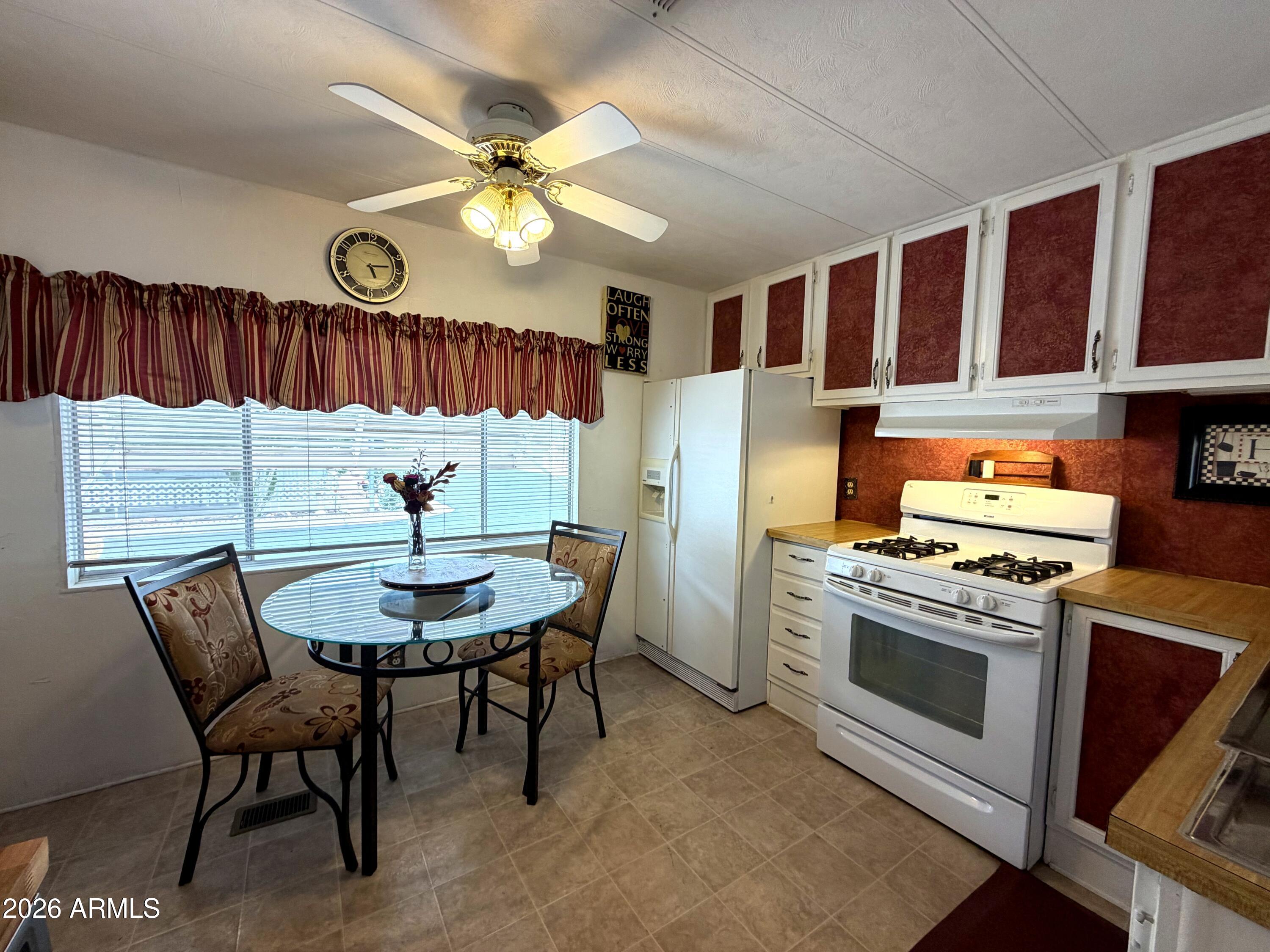 Charming and well-maintained 2-bedroom, 1-bath Villager mobile home in the desirable 55+ Meridian Park community in Apache Junction! This 14x60 (840 sq ft) home features a new $10K AC unit with warranty, three ceiling fans, and layered window coverings. The updated kitchen includes a new butcher block bar, six additional cabinets, a pantry, ample storage, plus a GE stack washer/dryer and Whirlpool dishwasher. The remodeled bathroom offers added cabinetry for convenience. Enjoy a large porch with beautiful sunset views. Also includes a 2-car carport, two storage sheds and enclosed pet area with turf and direct access. Meridian Park amenities feature a year round heated pool and spa, pickleball court, dog park, fitness room, clubhouse ample social events! Conveniently located near shopping, dining, and banking, and just 25 minutes from Sky Harbor. Lot rent is $700/month and includes water, septic, and trash services.