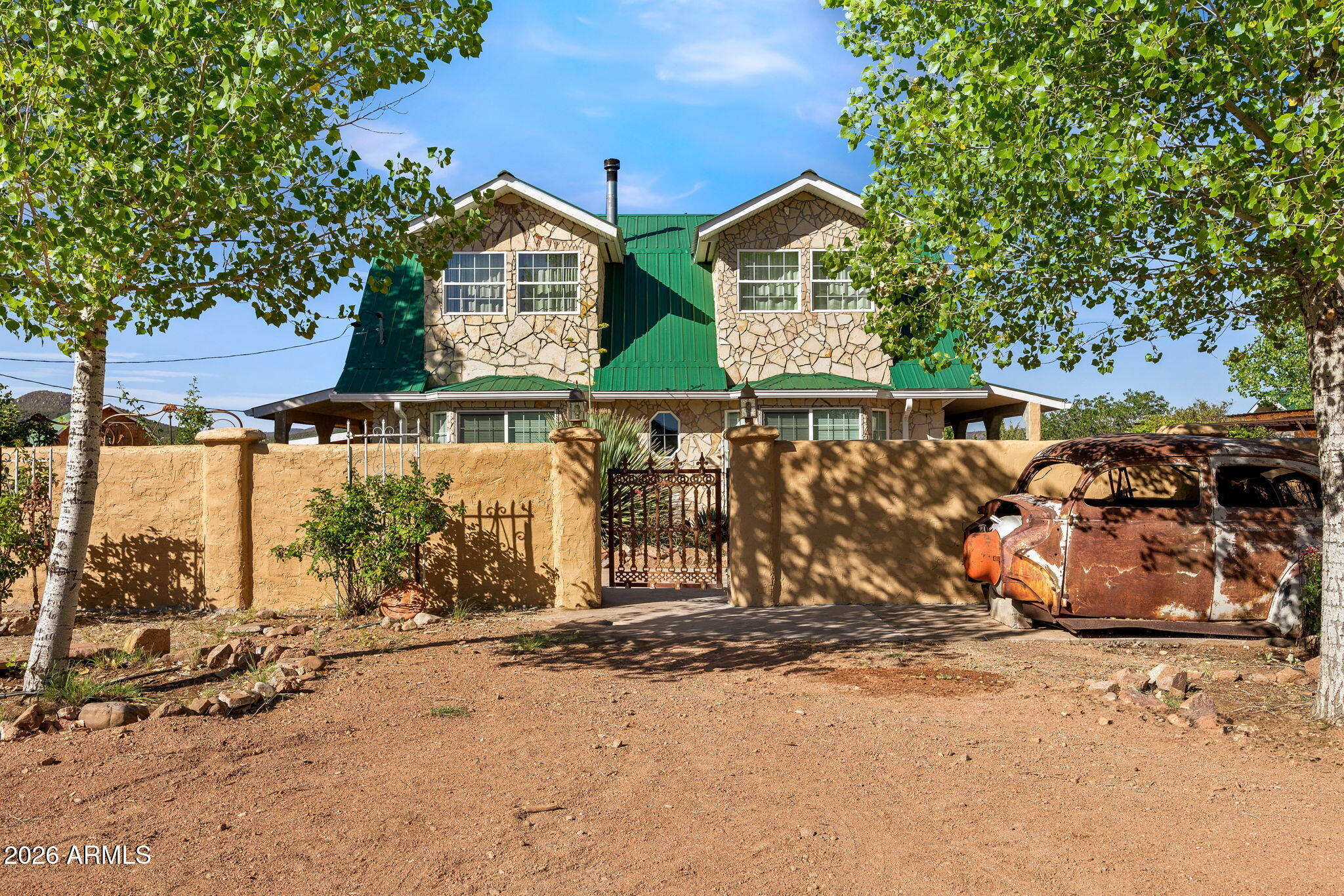 THE ULTIMATE MINI-FARM for SELF-SUFFICIENCY AT A MILE HIGH ELEVATION with a 9-MONTH GROWING SEASON and moderate winters! REAP THE REWARDS of FERTILE SOIL, FULLY FENCED GARDENING PLOTS, FACILITIES FOR STARTING TRANSPLANTS, HARVESTING / PROCESSING WINE GRAPES and other FRUITS; RAISING / PROCESSING BACKYARD LIVESTOCK. HIGH-PRODUCING WELL & WATER SYSTEM RUNS EFFICIENTLY with a Grundfos SOLAR SUBMERSIBLE PUMP to a large storage tank that's protected from the elements, to irrigate all crops, refill the pond and supply potable water for domestic use.  Home built by a licensed contractor in 1998 has 1996 sf with 3 bdrm 2 full baths+1/2 bath. Garage built in 1999 is entirely open 1200 sf with 12-ft high 16-ft wide RV door + 2 man doors & 200 volt receptacle with FURNISHED 1 bdrm 1.5 bath 1120 sf APARTMENT that has a private Bdrm;1.5 Baths; Kitch appliances W/D included -- on separate 200-amp electric service panel. TRI-LEVEL 24' X 24' BARN [576 sf] has both a mezzanine plus a hay storage loft; cattle stanchion for milking; fully enclosed meat processing room for butchering and packaging meat; also includes 220V receptacle; plus hoist for lifting and moving large game. Chicken coop and attached 8' X 9' greenhouse are in a separate building near the orchard. Equipment used for farming; handling livestock, meat processing, wine making, & apple pressing are included. Other personal property is negotiable. Entirely fenced with Mighty Mule brand entry gate. Seller will finance a qualified buyer at 5.5% interest rate; remaining terms to be worked out between seller and buyer.