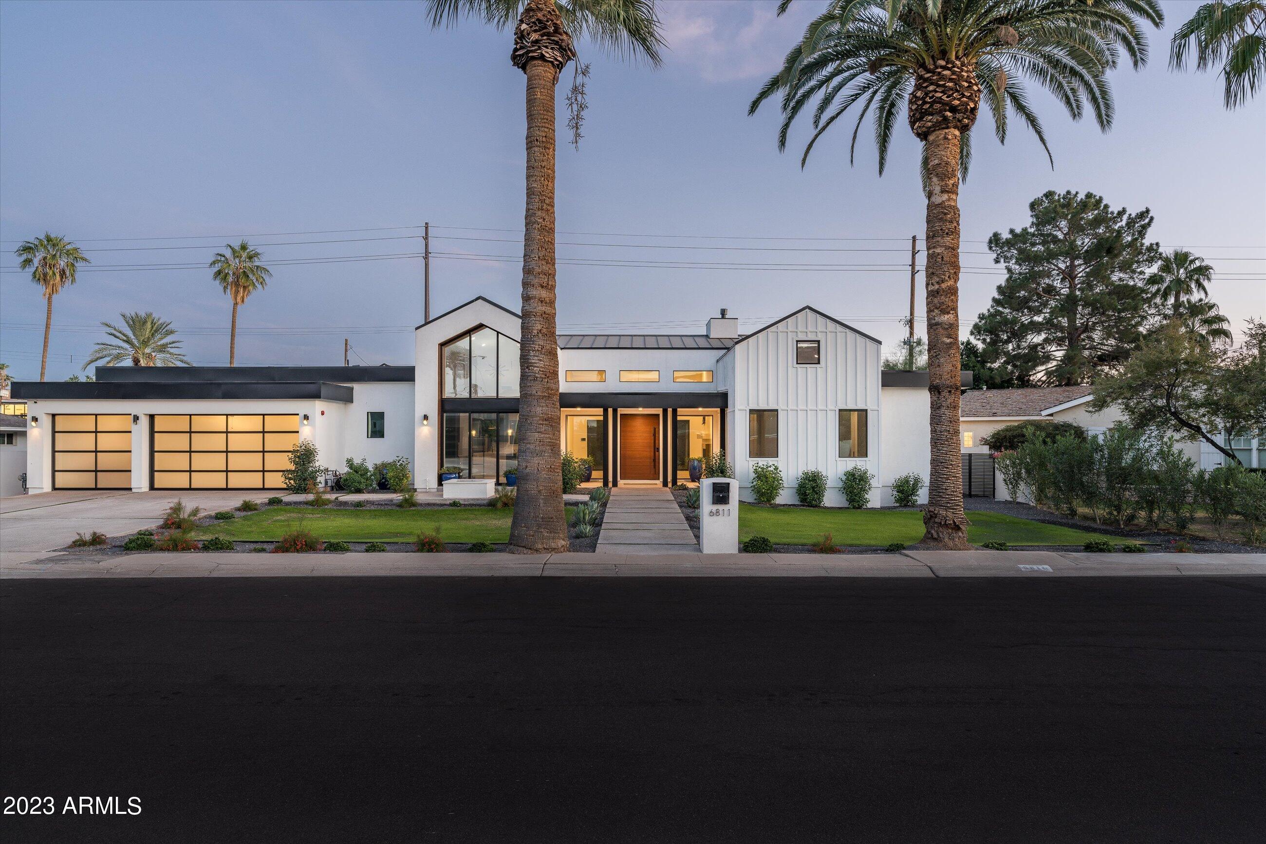 ** SELLER MAY ENTERTAIN SELLER FINANCING FOR THE RIGHT BUYER. ** STEP INTO THE LAP OF LUXURY WITH THIS STUNNING CONTEMPORARY RESIDENCE NESTLED IN THE SOUGHT-AFTER ARCADIA NEIGHBORHOOD OF SCOTTSDALE. NEWLY BUILT IN 2022, THIS HOME EMBODIES ELEGANCE AND SOPHISTICATION, CAPTURING YOUR ATTENTION WITH ITS SOARING CEILINGS AND AN ABUNDANCE OF NATURAL LIGHT POURING THROUGH CATHEDRAL AND CLERESTORY WINDOWS. THE HEART OF THE HOME LIES IN THE CHEF'S KITCHEN, A CULINARY HAVEN BOASTING TWO EXPANSIVE ISLANDS WITH EXQUISITE QUARTZ COUNTERTOPS. EQUIPPED WITH TOP-OF-THE-LINE DACOR STAINLESS STEEL APPLIANCES, INCLUDING A PROFESSIONAL-GRADE GAS RANGE AND DOUBLE OVENS, THIS KITCHEN IS DESIGNED TO ELEVATE YOUR COOKING EXPERIENCE. STORAGE IS ABUNDANT WITH CUSTOM CABINETRY AND A WALK-IN PANTRY. THE SLEEK DESIGN IS COMPLEMENTED BY TASTEFUL PENDANT LIGHTING, CREATING THEPERFECT AMBIANCE. THE OPEN LAYOUT SEAMLESSLY CONNECTS THE KITCHEN TO DINING AND LIVING AREAS, PROVIDING A HARMONIOUS FLOW FOR ENTERTAINING. THE DINING ROOM, WITH A WET BAR AND SLIDING GLASS DOORS OPENING TO A GAS FIREPIT, SETS THE STAGE FOR MEMORABLE GATHERINGS. STEP OUTSIDE TO A RESORT-STYLE BACKYARD WITH LANDSCAPED GARDENS, A BUILT-IN BBQ AREA, FIRE PIT, BAJA DECK, AND A HEATED SPA, CREATING A PRIVATE OASIS. THE HOME FEATURES A SPACIOUS MASTER RETREAT WITH A SPA-LIKE BATHROOM, FIVE BEDROOMS WITH WALK-IN CLOSETS, AND A VERSATILE BONUS ROOM. SMART HOME TECHNOLOGY CONTROLS LIGHTING, CLIMATE, SECURITY CAMERAS, AND MOTORIZED WINDOW TREATMENTS. WITH TWO AC ZONES, HIGHLY RATED INSULATION, AND ENERGY-EFFICIENT TINTED WINDOWS, THIS HOME COMBINES COMFORT AND EFFICIENCY. THIS IS YOUR CHANCE TO OWN AN EXCEPTIONAL HOME IN THE HEART OF ARCADIA/OLD TOWN SCOTTSDALE, CLOSE TO FINE DINING, WORLD CLASS SHOPPING, ART GALLERIES AND ENTERTAINMENT - SCHEDULE A SHOWING TODAY AND MAKE THIS DREAM HOME YOURS!
