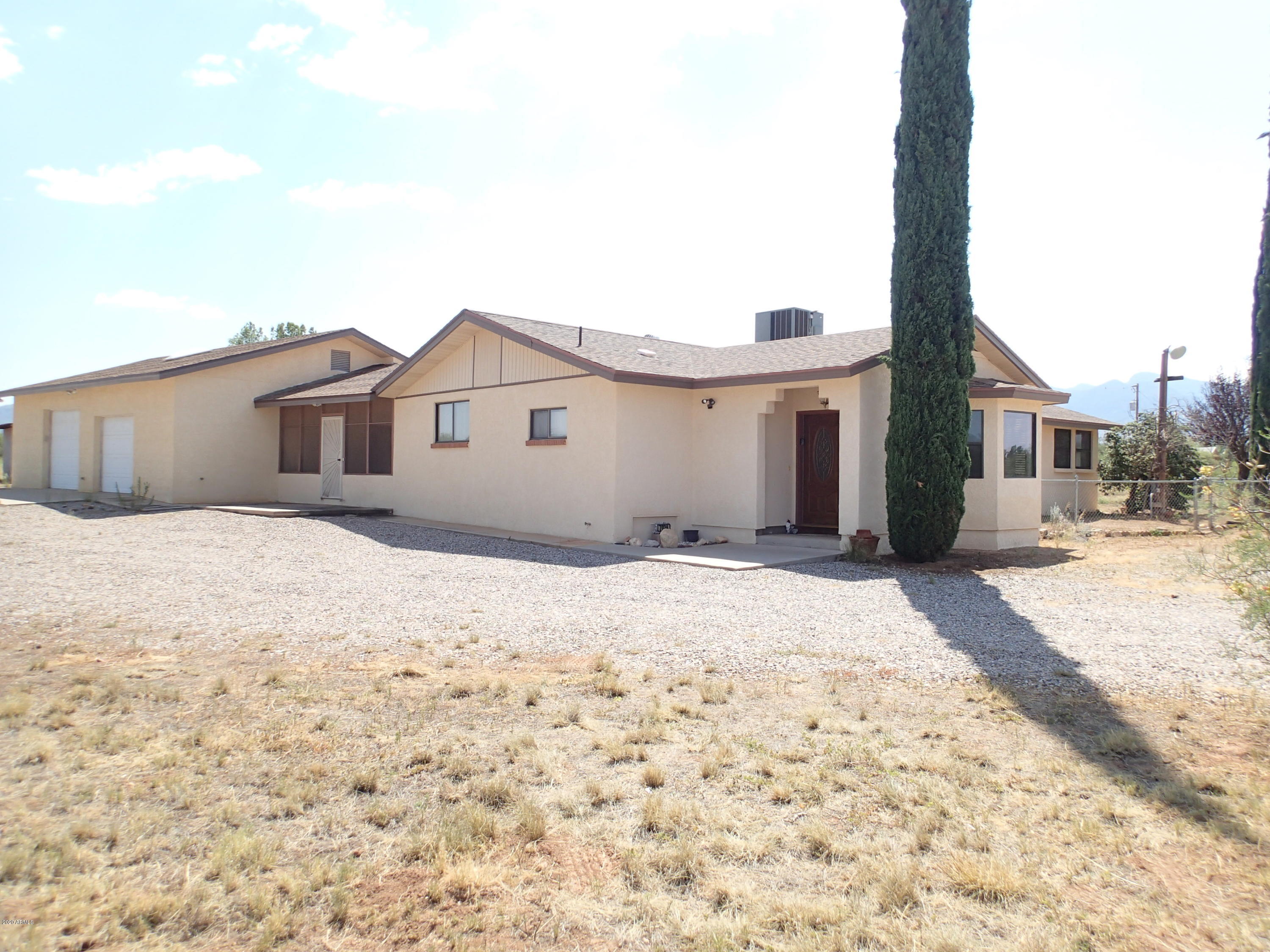 HUGE 30x40 Workshop/3 Car garage with 1/2 Baths on 4 Acres!! This 3 bedroom/2 bath home boast a 2162 sqft with large Foyer entry.  18'' Ceramic tile through out  except 2 rooms. Beehive Fireplace in Great room.  Nice wooden kitchen cabinets and ceramic countertops.  Large Laundry room with Cabinets+Countertops and built in File Cabinet. Master bedroom has a step in tile shower with beach seat.  Additional room off of bedroom with out side access. Chain link fenced in yard with patio. Screened in breeze way between home and massive garage. The 30x40 workshop has 200amp service. Heated and cooled, large doors and a half bath. Private Well.  Great Horse property.