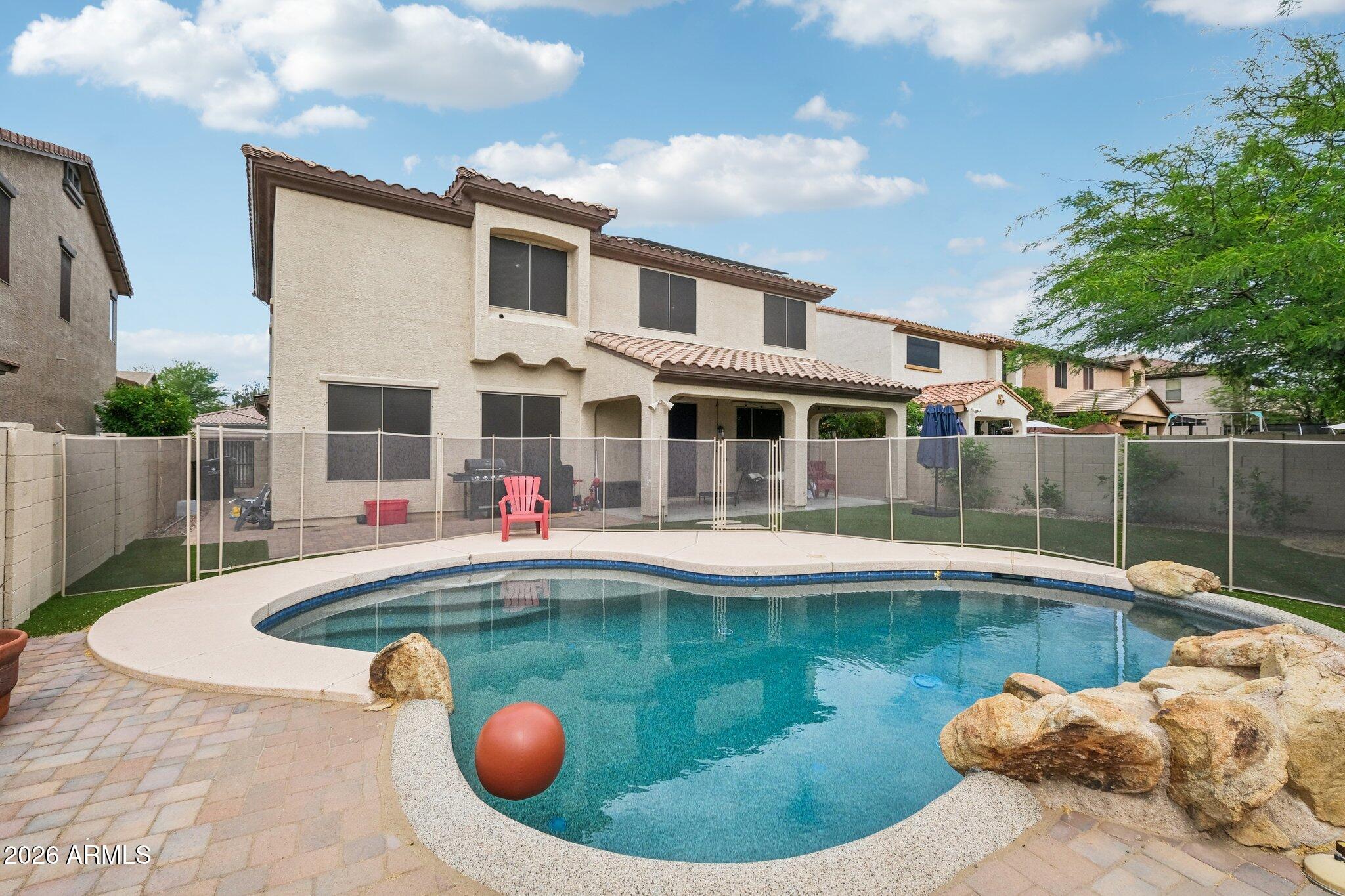 SOLAR SYSTEM IS PAID IN FULL!  Welcome to this spacious and energy-efficient home offering the perfect blend of comfort, style, and privacy. Featuring 5 generously sized bedrooms and 3 full bathrooms, this home provides ample space for family living, guests, or a home office setup. The 2.5-car garage offers exceptional storage options for vehicles, tools, and recreational gear.

Enjoy significant savings with owned solar panels--free and clear--helping reduce monthly utility costs. The home is also equipped with a water softener for added convenience and comfort.

Step outside to your private backyard retreat, complete with a fenced pool, newly installed artificial turf, and no neighbors behind--offering a rare level of peace and seclusion. It's the perfect space for relaxing, entertai or enjoying Arizona's beautiful weather year-round.

Inside, the kitchen was thoughtfully updated in 2024 with modern cabinetry and elegant quartz countertops, creating a stylish and functional centerpiece for the home.

As part of a well-maintained HOA community, residents enjoy access to a wide range of amenities including a pool, clubhouse, walking and biking paths, tennis and pickleball courts, a fitness center, and a children's playground.

This home truly checks all the boxes--space, upgrades, efficiency, and privacy--all in one exceptional property.