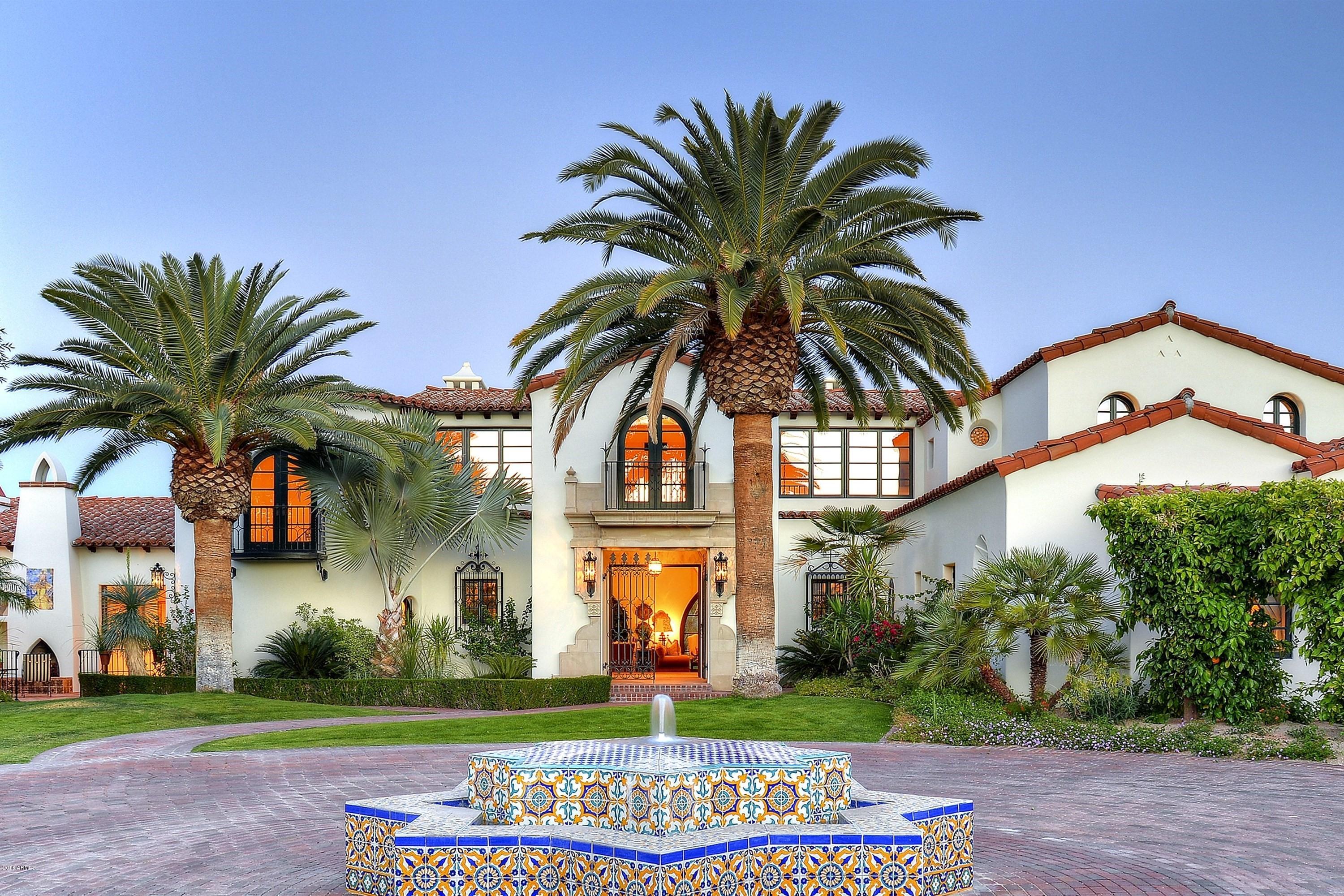 Beautiful, expertly crafted, and timeless, this extraordinary 2.7 acre gated estate is a rare and wonderful find.  Masterfully designed and executed, the ambiance of the home and grounds evokes feelings of warmth and tranquility.  Thoughtfully positioned on a large, private, and quiet lot, the home blends beautifully with the lushly landscaped grounds and offers gorgeous views of nearby Mummy Mountain.  The home showcases exceptional craftsmanship, materials, and design. Limestone and wood floors, imported antique stone fireplaces, wood beamed ceilings, hand forged ironwork, French doors, and fine marble countertops, flawlessly create an ambiance of beauty and quality.  Whether entertaining many, or having a quite intimate gathering, all will be touched by this extraordinary estate.