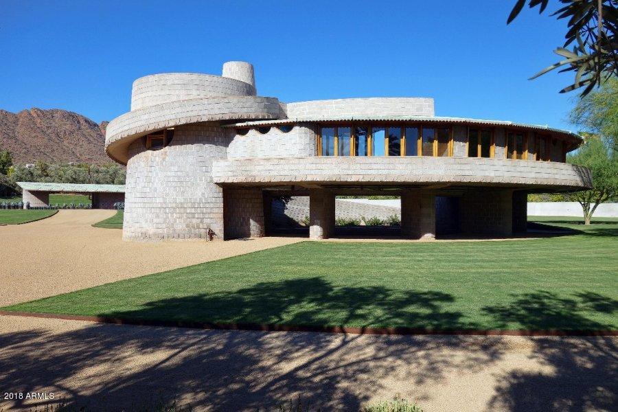 Completed in 1952, the David and Gladys Wright House is one of three spiral designs realized by Frank Lloyd Wright and is considered to be a precursor to the Guggenheim Museum in New York City. The concrete block home sits on ~5.9 acres in the Arcadia neighborhood of Phx and enjoys sweeping views of Camelback Mountain.  The ~2200 SF 3 bdrm main house has been partially updated, but requires additional rehabilitations, including necessary structural and electrical repairs. The offer includes reproductions of the signature ''March Balloons'' carpet designed by Wright for the living room and a dining table and chairs. The ~360 SF 1 bd guest house has been recently restored. An application for Historic Preservation-Landmark status is pending with the City of Phoenix.Offered in AS-Is condition