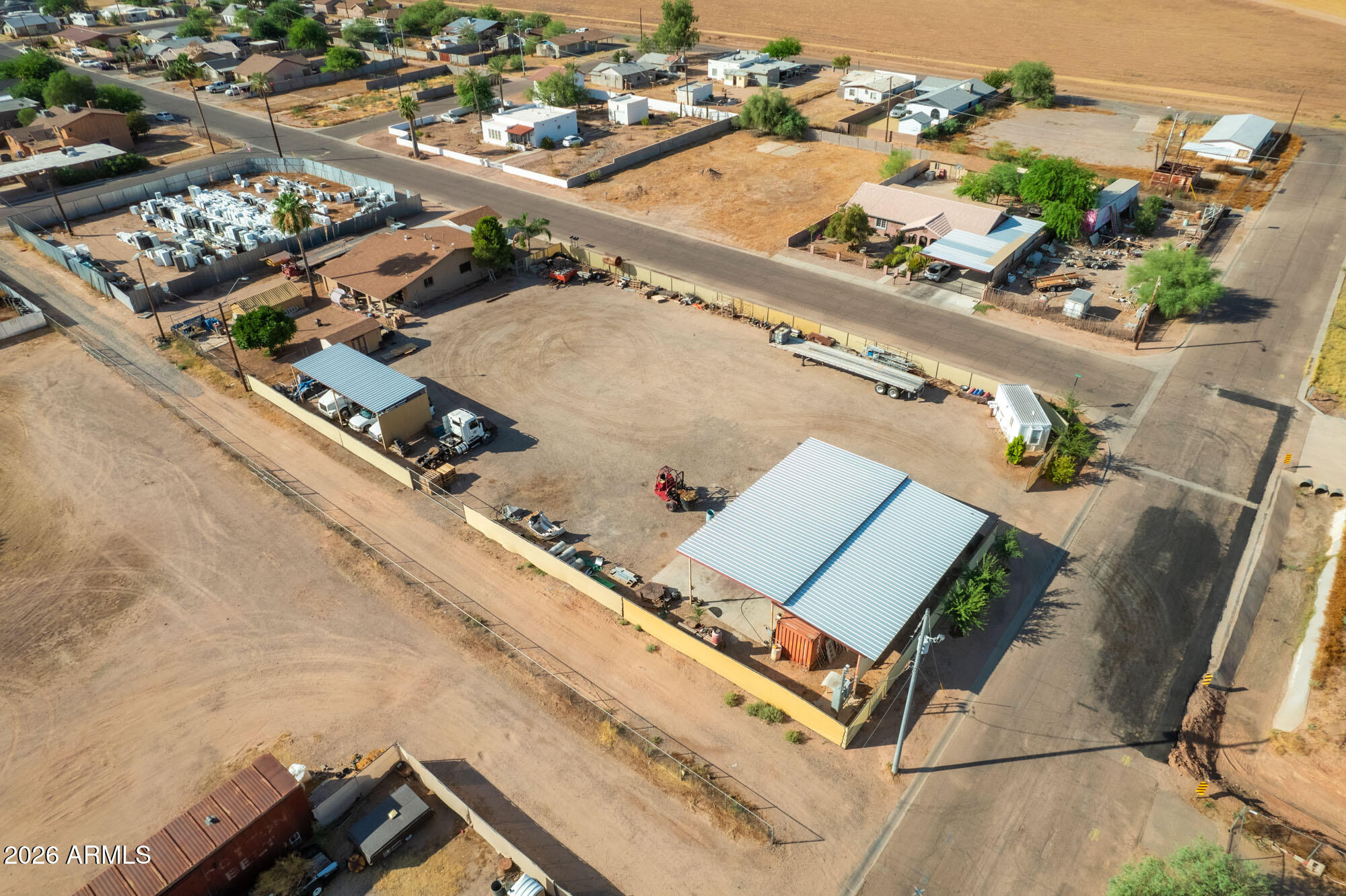 Ideal location for equipment or trucking operation! 2 parcels netting 25,500 sqft. 8 x 20 office, 50' x 25' steel shade structure with concrete floor and 400 amp outlets, another 40' x 15' steel shade structure.