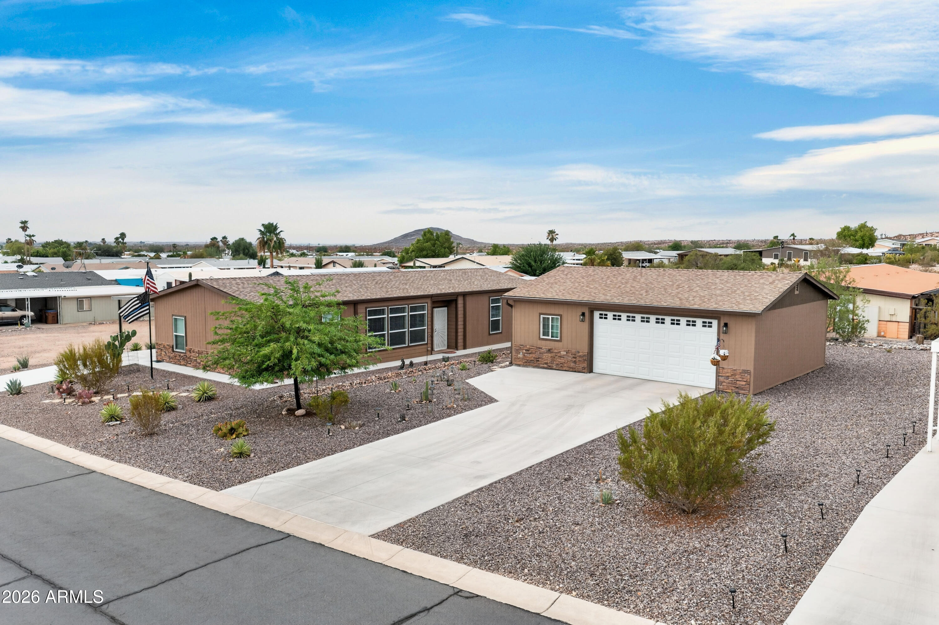 Desert charm meets modern comfort on an oversized double lot in Florence! This 3 bedroom, 2 bath home offers 1,620 sq ft of thoughtfully designed living space with a desirable split floorplan for privacy. The open concept with a gourmet kitchen impresses with rich cabinetry, stainless steel appliances, a large island with breakfast bar seating, and a hidden pantry for extra storage. Durable LVP flooring flows throughout the main living areas, complemented by crown molding & tray ceiling in the great room. Dining and living spaces are bright and open, ideal for entertaining, including a hidden pantry for storage! Spacious 26x32 garage/workshop with extra driveway parking. Located in a well established Florence neighborhood & easy access to local amenities and stunning desert views.
