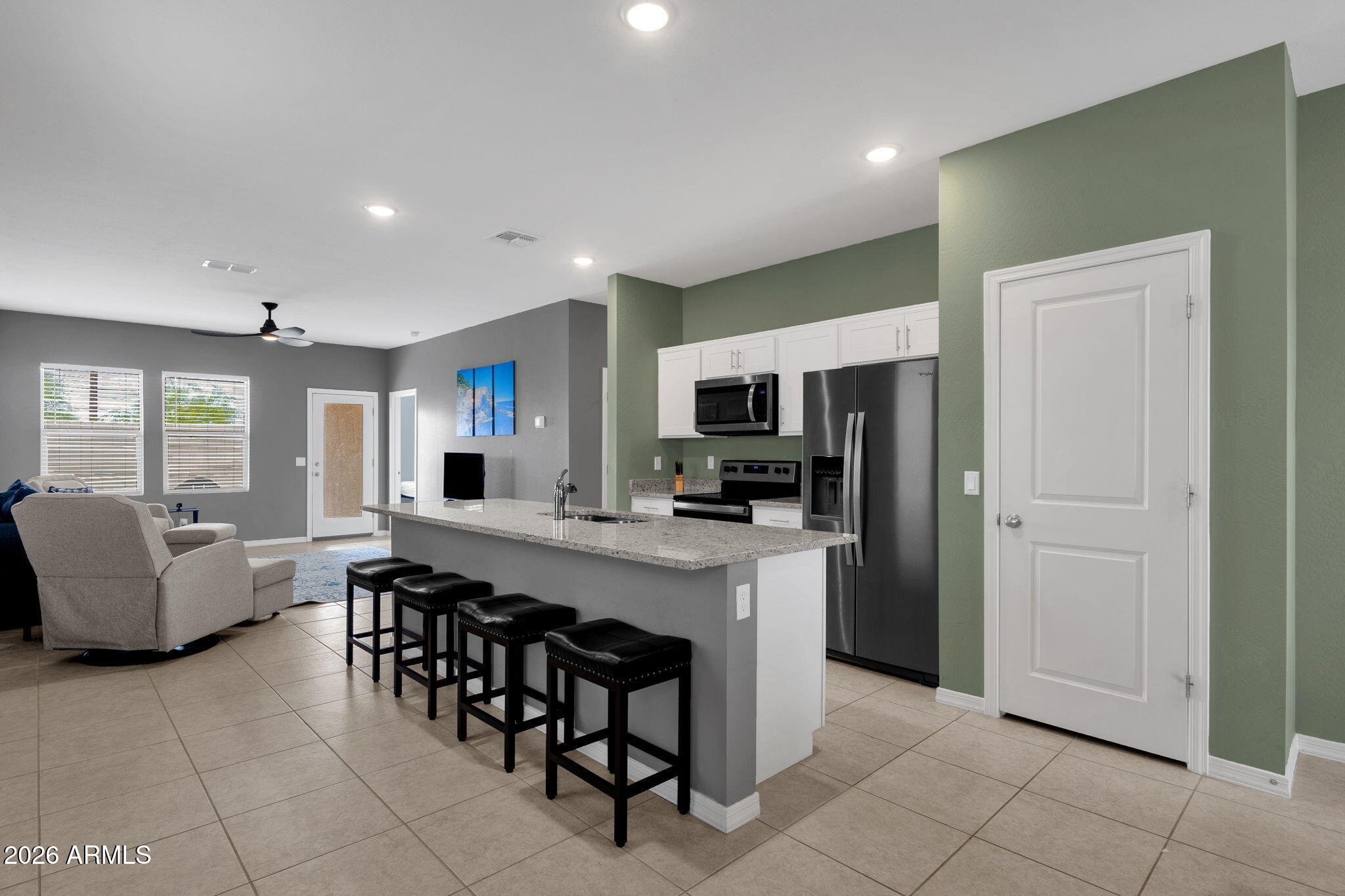 FULLY FURNISHED, WORKING AIRBNB! Built in 2023 in Amarillo Creek, this single-level 3 bed, 2 bath Maricopa home offers approx. 1,402 sq ft with a clean, open layout and low-maintenance design. The kitchen features granite countertops, white cabinetry, stainless steel appliances, recessed lighting and a large island with breakfast bar seating, opening to the dining area and living room for an easy everyday flow. Tile flooring extends through the main living areas, with carpet in the bedrooms. The primary suite includes an ensuite bath with dual-sink vanity and walk-in shower. Outdoor space includes a covered patio, block-fenced backyard, grass area and desert rock border for manageable upkeep. The 2-car garage includes overhead storage racks and an epoxy-style floor coating, creating useful space for parking, bikes, tools fitness equipment or extra storage. Desert front landscaping adds curb appeal with minimal maintenance. Furniture included in the sale of the home. Seller Updates, new flooring (2023); freshly painted interior (2023); custom closets and laundry storage (2023).
Amarillo Creek community amenities include green space, parks, playgrounds, trails, soccer fields, pickleball courts and basketball courts. Convenient Maricopa location with quick access to John Wayne Pkwy / SR 347 for commuting toward Chandler, Phoenix and Laveen, plus nearby shopping, dining, city parks and entertainment including Copper Sky Regional Park, Pacana Park and Ak-Chin Circle Entertainment Center. A newer Maricopa home with open living space, practical storage, covered outdoor space and access to community amenities!