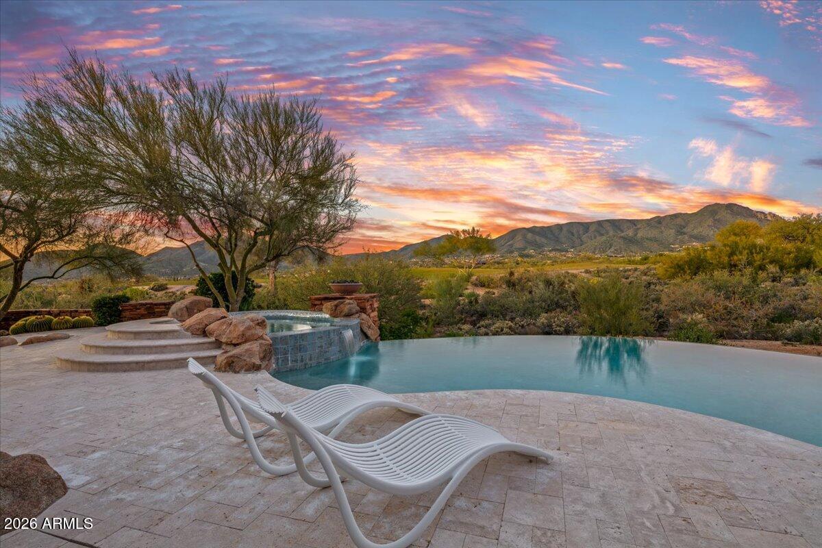 Stunning Desert Mountain estate with FULL GOLF MEMBERSHIP, fully Furnished and remodeled 2023-2024 has everything you could wish for . A romantic Lee Hutchison Masterpiece, this 7,447 sq ft home sits on 1.7 acres across two lots with exceptional privacy, golf courses and panoramic Continental Mountain views. Features include 4 bedrooms, 6 baths and 9 fireplaces. Resort-style outdoor living offers new travertine decking, resurfaced pool, spa, fire pit, Alfresco grill and multiple seating areas. Inside, the new gourmet kitchen includes quarter-sawn Plato cabinetry, Thermador appliances, Smeg espresso maker and quartzite counters. Great room has curved quartzite bar, wine cooler, 100'' TV and mountain views. Luxurious primary suite with fireplace, SDH bedding, quartzite bath and custom closet. Large guest casita with fireplace. Extensive mechanical updates: new HVAC (primary & casita), new tankless water heaters, new water service, new water softener, new security system, and more. Move-in ready perfection in Desert Mountain. And, we have a "ramp" option as well, if you prefer no steps!