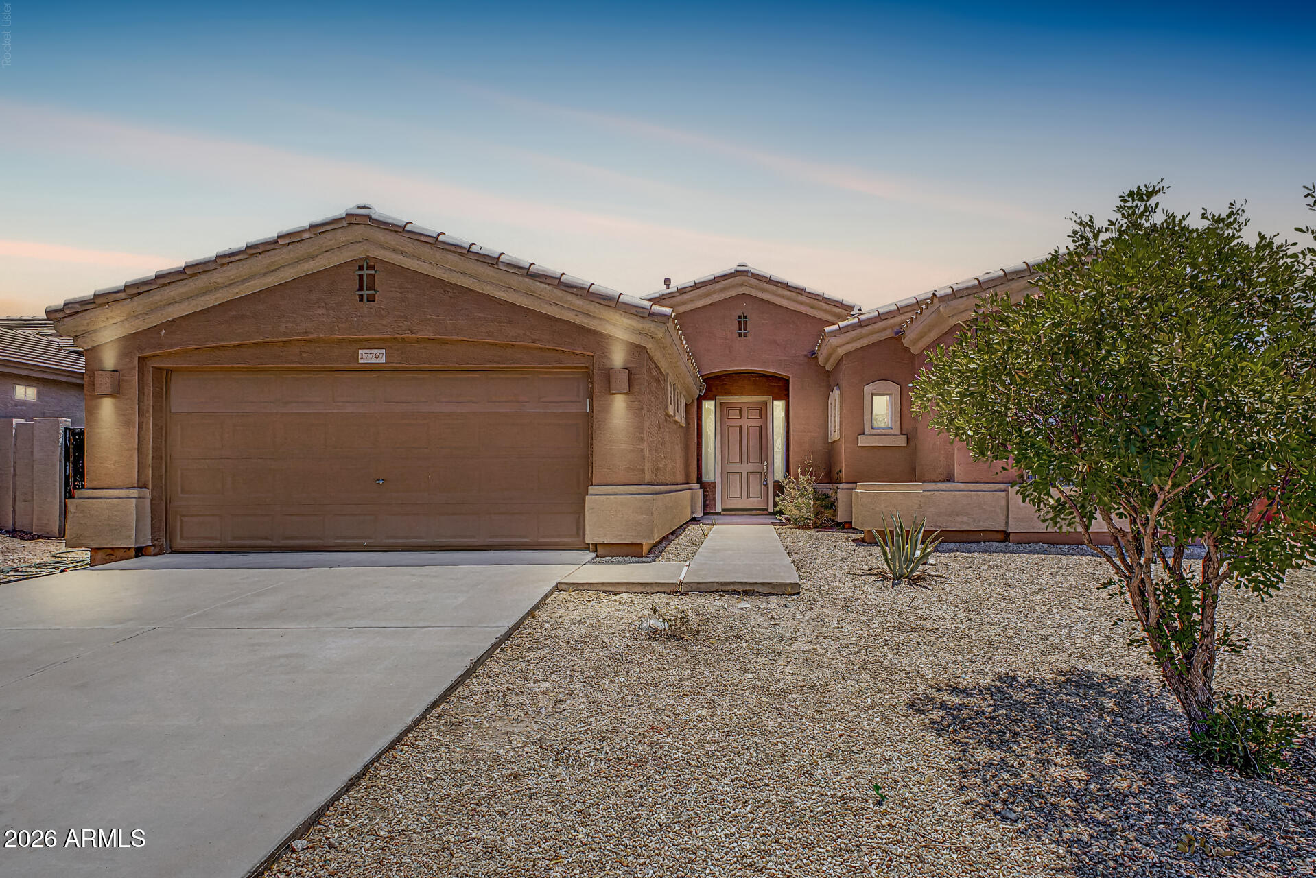 Stunning corner lot in Estrella Mountain Ranch with no back neighbor! Nearly 2,000 sq ft of living space on a 7,000+ sq ft lot, with fresh paint and new carpet throughout, tall ceilings, and big windows that fill the home with light. The showstopper kitchen brings quartz counters, stainless appliances, recessed lighting, tile backsplash, a walk-in pantry, and an island with breakfast bar seating. Four bedrooms and two updated baths, including a primary suite with dual sinks, a soaking tub, a glass-enclosed shower, and a walk-in closet. Out back, a covered patio, low-maintenance landscaping, and open space behind the fence. Leased solar helps keep summer utility bills down. And it all comes with Estrella living: lakes, trails, golf, and residents clubs!