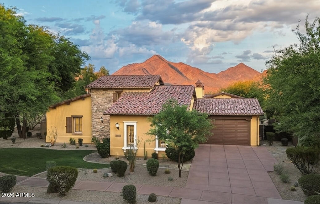 Nestled on one of the largest lots in the prestigious gated Haciendas enclave of DC Ranch, this exceptional single-level Camelot Homes residence offers timeless architecture, thoughtful design, and breathtaking McDowell Mountain views. Positioned on a premium corner lot with protected preserve land behind, the property enjoys a rare combination of privacy, open space, and unobstructed desert vistas.
A welcoming entry courtyard with a gas fireplace sets the tone for the home's seamless indoor-outdoor living. Inside, soaring 12-14 foot ceilings, custom wainscoting, rich wood cabinetry, and graceful archways create warmth and character throughout. The spacious floor plan features a double-sided gas fireplace, formal dining room with butler's pantry, dedicated office, and integrated surround sound in the main living spaces.

The attached two-room casita is thoughtfully appointed with a kitchenette, full bath, and walk-in closet, offering exceptional flexibility for guests and extended stays. The primary suite showcases stunning McDowell Mountain views and a dramatic custom coffered barrel-vault ceiling. Two additional bedrooms in the main residence are connected by a Jack-and-Jill bathroom, providing a thoughtful and functional layout. Expansive picture windows and French doors open to the resort-style backyard, creating a seamless connection between indoor and outdoor living.

Designed for both entertaining and relaxation, the backyard features a heated pool with waterfall, heated spa, fire pit, ramada, oversized lawn, and private basketball sport court, all overlooking protected preserve land with no homes behind.

Additional highlights include a three-car garage, neighborhood park directly across the street, and access to DC Ranch's extensive trail system, Community Center, fitness facilities, pickleball and tennis courts, pools, and Market Street dining.

A rare opportunity to own one of Haciendas' premier properties in one of North Scottsdale's most sought-after communities.
