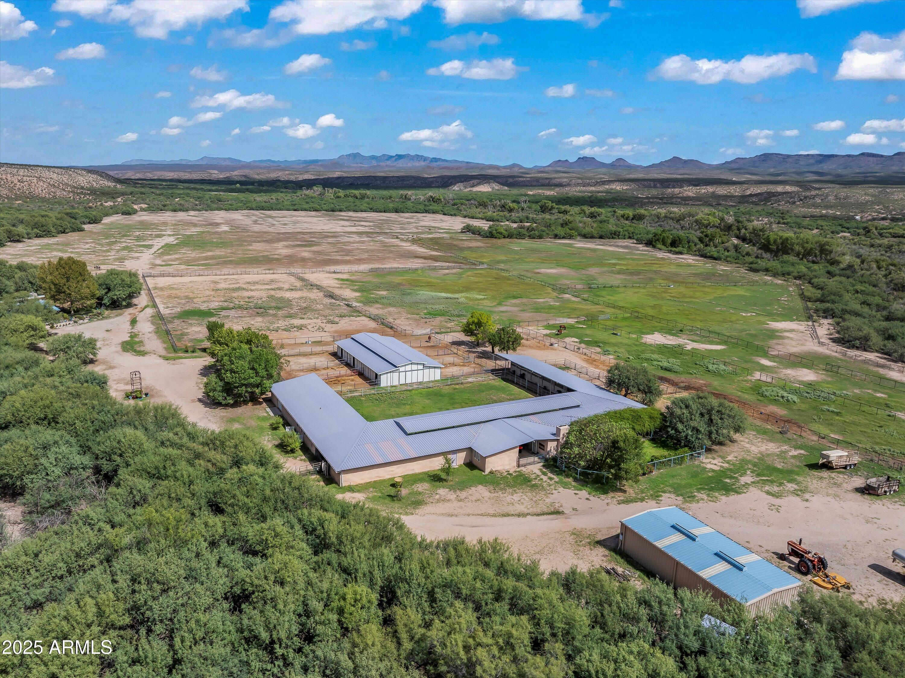 Escape to Your Own Paradise in Benson, Arizona-- A Dream Property for Ranchers, Farmers, Horse Lovers or Retirees! Set along the San Pedro River that offers the freedom and functionality every landowner dreams of. This 254-acre Arizona ranch for sale offers unmatched privacy and endless potential. Perfect for expanding your ranch or farm, growing your agriculture business, building an equestrian/livestock/farming facilities, creating a premier hunting or tourist retreat, or establishing a quiet Western haven perfect for retirees seeking space and serenity. Whether you're a rancher, farmer, horse owner, or retiree seeking peaceful rural property in Benson, AZ, this wide-open acreage offers the freedom to live the lifestyle your way. LAND & WATER:
50+ irrigated pastures - irrigation well pumps 800 - 1000 gallons a minute
Two domestic wells
1 livestock well
1 septic tank
Spring-fed pond ideal for fish, waterfowl, & wildlife
Fencing: Welded pipe and mesh surrounding the headquarters and irrigated pastures.
Combination of electricity and solar panels

RESIDENCES:
2,400 sqft rammed earth main home
Open floor plan with 360-degree view of the property, large stone fireplace, commercial kitchen w/pantries, Arizona room, 2bed/2bath, and more
1,200 sqft straw bale ranch home
Covered with historic Tombstone Rose, with a fireplace in the living space, 2bed/1bath, and more
Studio apartment or office & large storage space
Multiple carport structures for vehicles or equipment

EQUESTRIAN & LIVESTOCK INFRASTRUCTURE:
Two barns with 19 stalls to accommodate any type of breeding program
Working corrals & round pen
Tack & feed rooms
Covered hay & equipment storage
Squeeze chute for livestock
Pastures designed for isolation, breeding, and disease prevention

LIFESTYLE & RECREATION:
Adjacent to the International Bird Sanctuary
360° mountain and desert views
Home to rare and migratory species, perfect for bird watching
Hiking, fishing, horseback riding, and wildlife observation
Unique desert flora including rare blooming cactus
Located in a development-protected area no neighbors, no noise, no pollution.

LOCATION:
22 miles from Benson, AZ including 12 miles scenic unpaved road or with access to Cascabel Highway. A peaceful drive through Arizona's untouched high desert landscape sets the stage for the tranquility and beauty that awaits.

This is Arizona's desert gem a one-of-a-kind oasis hideaway surrounded by natural beauty. Don't miss this rare opportunity to own one of Southern Arizona's most unique and versatile properties.