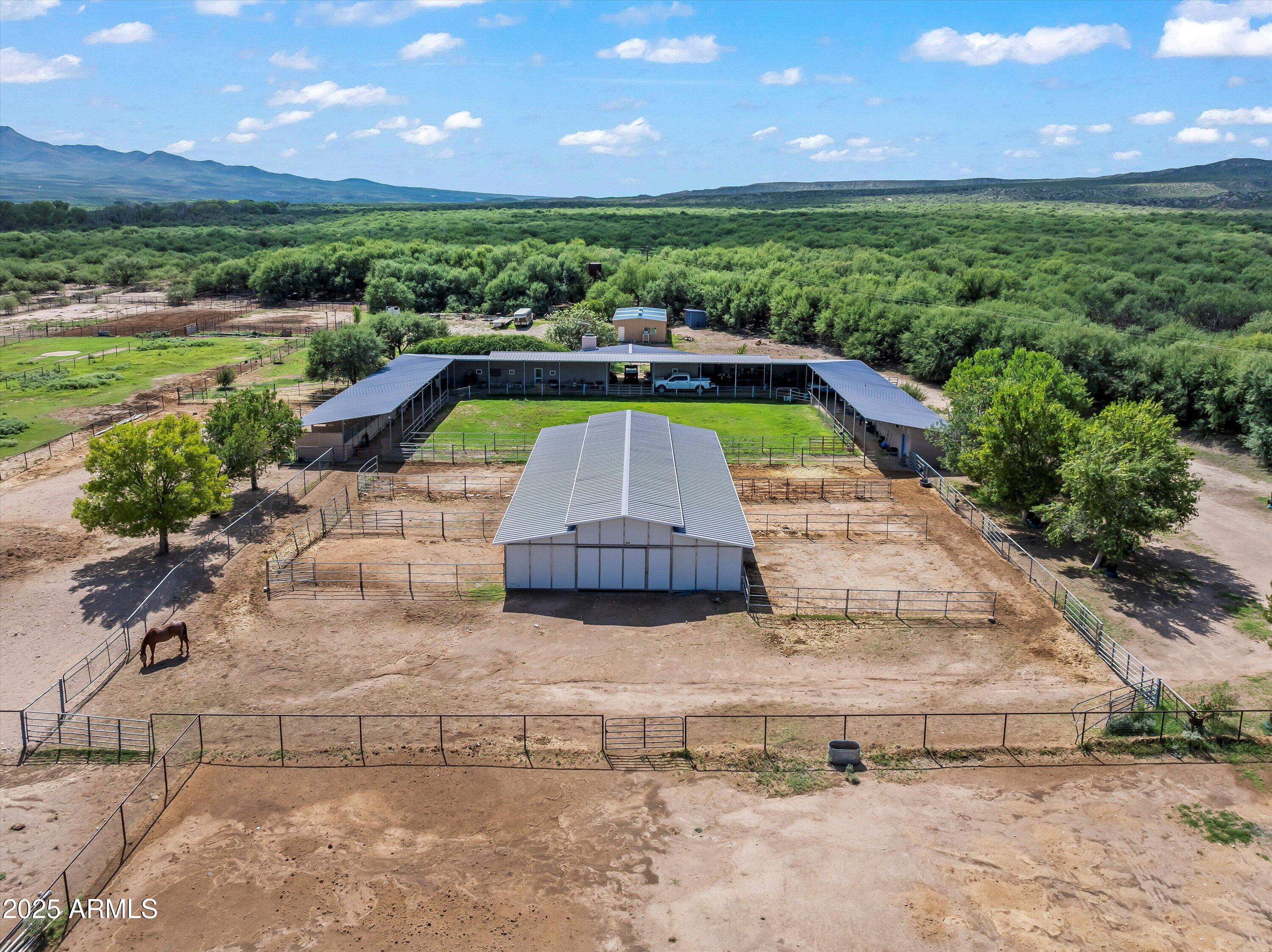 Escape to Your Own Paradise in Benson, Arizona-- A Dream Property for Ranchers, Farmers, Horse Lovers or Retirees! Set along the San Pedro River that offers the freedom and functionality every landowner dreams of. This 254-acre Arizona ranch for sale offers unmatched privacy and endless potential. Perfect for expanding your ranch or farm, growing your agriculture business, building an equestrian/livestock/farming facilities, creating a premier hunting or tourist retreat, or establishing a quiet Western haven perfect for retirees seeking space and serenity. Whether you're a rancher, farmer, horse owner, or retiree seeking peaceful rural property in Benson, AZ, this wide-open acreage offers the freedom to live the lifestyle your way. LAND & WATER:
50+ irrigated pastures - irrigation well pumps 800 - 1000 gallons a minute
Two domestic wells
1 livestock well
1 septic tank
Spring-fed pond ideal for fish, waterfowl, & wildlife
Fencing: Welded pipe and mesh surrounding the headquarters and irrigated pastures.
Combination of electricity and solar panels

RESIDENCES:
2,400 sqft rammed earth main home
Open floor plan with 360-degree view of the property, large stone fireplace, commercial kitchen w/pantries, Arizona room, 2bed/2bath, and more
1,200 sqft straw bale ranch home
Covered with historic Tombstone Rose, with a fireplace in the living space, 2bed/1bath, and more
Studio apartment or office & large storage space
Multiple carport structures for vehicles or equipment

EQUESTRIAN & LIVESTOCK INFRASTRUCTURE:
Two barns with 19 stalls to accommodate any type of breeding program
Working corrals & round pen
Tack & feed rooms
Covered hay & equipment storage
Squeeze chute for livestock
Pastures designed for isolation, breeding, and disease prevention

LIFESTYLE & RECREATION:
Adjacent to the International Bird Sanctuary
360° mountain and desert views
Home to rare and migratory species, perfect for bird watching
Hiking, fishing, horseback riding, and wildlife observation
Unique desert flora including rare blooming cactus
Located in a development-protected area no neighbors, no noise, no pollution.

LOCATION:
22 miles from Benson, AZ including 12 miles scenic unpaved road or with access to Cascabel Highway. A peaceful drive through Arizona's untouched high desert landscape sets the stage for the tranquility and beauty that awaits.

This is Arizona's desert gem a one-of-a-kind oasis hideaway surrounded by natural beauty. Don't miss this rare opportunity to own one of Southern Arizona's most unique and versatile properties.