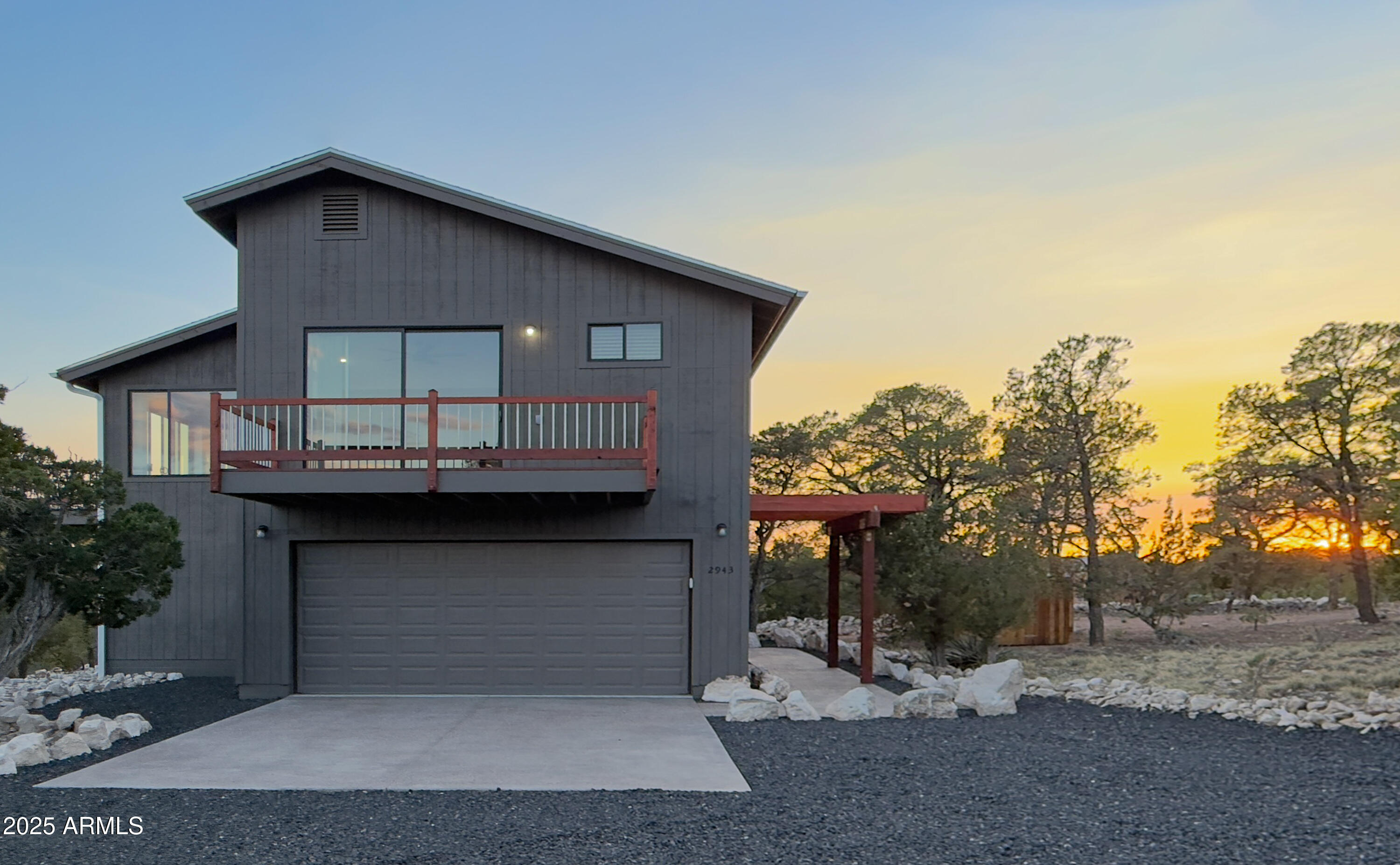 Looking for your perfect escape from triple-digit summers? This modern mountain retreat in Overgaard sits at 6,600 feet elevation, where cool pines replace scorching pavement and the Mogollon Rim becomes your backyard. And getting here just got easier: the seller is offering private financing at 4% interest with 25% down, and is open to trading for a home in the Phoenix metro area. Two creative paths to ownership, one extraordinary destination.
The unforgettable Mogollon Rim views steal the show in this modern mountain retreat, designed to bring nature to your doorstep, which is best experienced in person. Perched on a private, firewise corner lot, this south-facing stunner features expansive glass doors, multiple wood balconies, and sleek interior finishes including solid oak flooring, peacock slate bathrooms, and a premium LG kitchen with induction range. A full guest studio with private entry, kitchen, and bath offers flexible living for guests, multigenerational households, or even summer cooking.

Step inside and you'll feel it immediately: this is not just a home... it's a retreat. A place to reset, reconnect, and unwind. South-facing windows frame an ever-changing panorama of the Mogollon Rim, with sunlight dancing through the trees and into the heart of the home. The open-concept great room flows seamlessly to outdoor decks perfect for sipping coffee at sunrise, sharing wine at sunset, or simply breathing in the fresh mountain air. Whether you're entertaining or savoring quiet solitude, nature is always in view.

The main kitchen is as refined as it is functional, featuring granite counters, sleek cabinetry, and top-of-the-line LG appliances including an induction cooktop with air-fry feature. A second full kitchen on the lower level offers added convenience, doubling as a summer kitchen or a fully independent suite for long-term guests.

Planning to age in place, accommodate varying mobility levels, or just enjoy an easier way to bring up your gear and groceries? The built-in elevator provides smooth access to the upper level -- perfect for second homeowners, multigenerational living, or those who simply prefer an effortless lifestyle.

Bathrooms are elevated with spa-like slate and granite finishes, walk-in showers, river rock floors, upgraded fixtures, and fan timers. From the heated, epoxy-coated garage and programmable thermostats to the seamless rain gutters and leveler blinds, no detail was overlooked. A central vacuum system, 200-amp electric service, and electric water heaters with timers add to the home's quiet efficiency. Roof is composite with a lifetime manufacturer's guarantee.

Outside, fire-resistant native landscaping blends beauty with safety, while a rounded driveway ensures ease of access year-round. Central A/C keeps you comfortable through every season.
Whether you're seeking a high-end primary residence or a lock-and-leave second home, this one-of-a-kind property offers the lifestyle you've been dreaming about. Photos can't fully capture the calm. Drive through the neighborhood. Sit on the balcony. Feel what it's like to live above it all.
