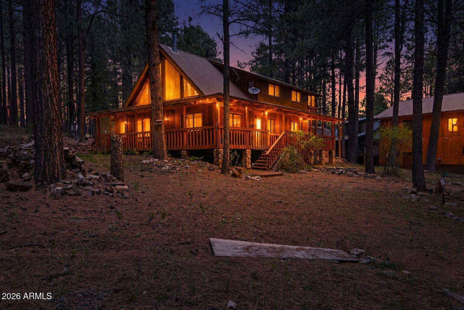 Forest Lakes Retreat on the Mogollon Rim - Cabin + Guest Quarters with Room for Everyone

Welcome to your perfect mountain escape in the highly sought-after community of Forest Lakes, nestled among the tall mountain pines along the breathtaking Mogollon Rim. This spacious chalet-style cabin offers the ideal blend of rustic charm and exceptional functionality, designed to comfortably host family, friends, and guests.

The main cabin features a dramatic great room with a stunning wall of chalet windows that brings the beauty of the outdoors inside, filling the home with natural light and peaceful forest views. With three bedrooms, two baths, and a large loft offering abundant additional sleeping space and its own walk-out balcony, there's room for everyone to relax and unwind. Step outside onto the covered wraparound deck--perfect for morning coffee, outdoor dining, or simply soaking in the cool mountain air beneath the pines.

Adding incredible value and versatility, the detached heated and insulated garage is extra deep for additional parking, toys, or workshop space. Above the garage, you'll find a fully equipped 1,200 sq. ft. additional dwelling unit complete with a spacious living area, full kitchen, private bedroom, indoor laundry, and its own covered walk-out balcony. This separate guest quarters is ideal for extended family, visitors, or even potential rental income.

With multiple living areas, generous sleeping accommodations, and peaceful forest surroundings, this property is perfectly suited for large gatherings, multi-generational living, or creating lifelong memories in Arizona's high country. A rare opportunity to own a true Forest Lakes retreat with space, privacy, and endless possibilities.