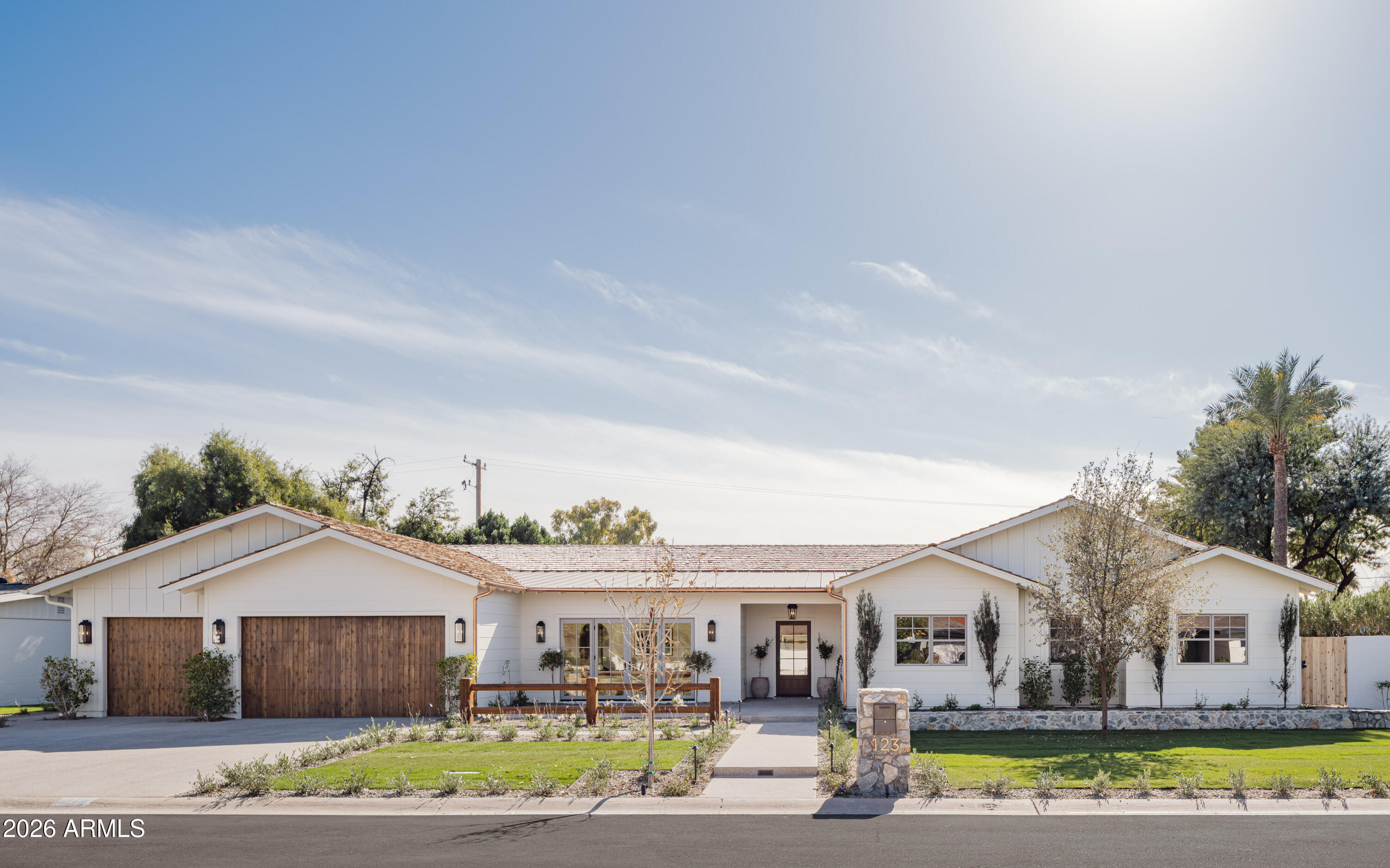 A thoughtfully designed custom ranch by Coyote Development, this newly constructed home sits on a one-third-acre lot in the heart of North Central Phoenix, just steps from Murphy's Bridal Path. The single-story, 5,166-square-foot residence blends timeless architecture with modern convenience and is thoughtfully designed for both everyday living and effortless entertaining.

The home honors its historic neighborhood with a cedar shake roof, vaulted ceilings with exposed beams, oak floors, and custom millwork throughout. At the center of the home is a chef's kitchen featuring Sub-Zero and Wolf appliances, a Taj Mahal quartzite island, and a fully equipped butler's kitchen with its own sink, dishwasher, built-in wine refrigerator, and second refrigerator. The kitchen opens to a spacious living room surrounded by French doors and anchored by a striking stone fireplace.

The front sitting room offers flexible use as a home office, lounge, or formal dining room, with French doors opening to the front social patio. All five generously sized bedrooms include en suite baths, offering comfort and privacy for both family and guests.

Smart space planning and storage are integrated throughout the home, including a large laundry and mudroom with double washers and dryers, a sink, and ample storage, as well as an oversized three-car garage with attic access.

The backyard is a private retreat, featuring a full ficus hedge, a marble-decked pool, and generous areas for outdoor entertaining.