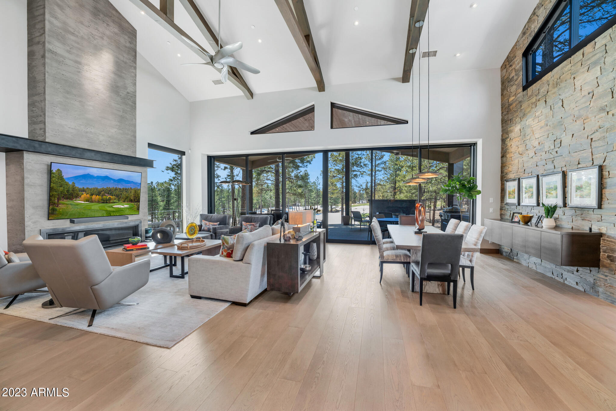 This truly custom one-of-a-kind home sits on the 5 par 4th fairway and overlooks the 7th fairway of Pine Canyon's award-winning golf course. Take in the breath-taking views from the beautiful covered back deck that also includes a linear fireplace, EVO built-in grill, Dekton countertops, and surround sound. Access to the back deck from the living room is a breeze through the 10ft Fleetwood glass doors including a full screen system. The gorgeous living room and entry are accented by vaulted ceilings, exposed wood beams, wood flooring throughout, and an expansive linear fireplace with a custom concrete mantle and metal hearth. This floorplan is perfect for entertaining as this home is all single level and the kitchen, dining area, living room and deck all flow seamlessly together. The kitchen is a chef's dream and features a spacious island with bar seating, 5 burner cooktop, 2 Miele dishwashers, a Wolf combo-steam oven and an additional wall oven, built-in microwave, and a wine refrigerator. The primary bedroom includes 2 exits to the back deck and an additional exit to another private deck, linear fireplace, and spacious bath with dual vanities, a makeup vanity, roomy shower with waterfall shower head, and large walk-in closet. 

2 additional en-suite guest rooms finish out the inside of this home. Both with unique custom bathrooms. 

A casita with outdoor access was added in 2021 and features a small kitchenette with mini-fridge and a full bathroom.  

This home was professionally decorated by Julie White at J White Designs. Additional features include an office area off the kitchen, floating cabinets, stone accent walls, custom lighting fixtures, automatic blackout blinds throughout, a 3 car garage with epoxy flooring, and dog run off the back deck. 

(Please view Semi-Private Remarks and Office Remarks)
