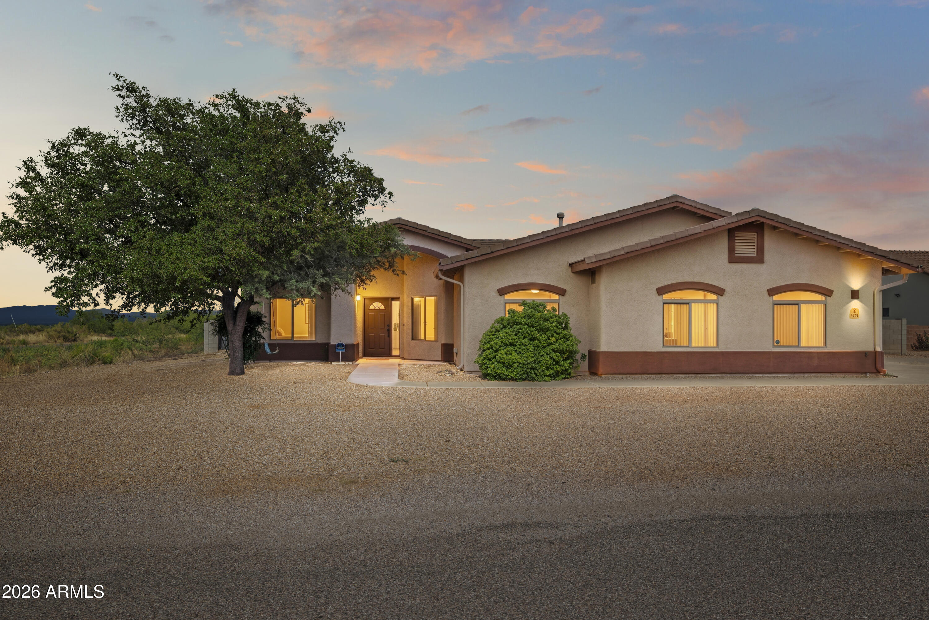 Enjoy beautiful mountain views from this spacious 4-bedroom, 2-bath home situated on a private corner lot. The open great room floor plan flows seamlessly into a bright kitchen featuring a large island with breakfast bar, ample cabinet space, and plenty of room for gathering. The split-bedroom layout includes a spacious primary suite with an en suite bath, while the additional bedrooms offer flexibility for family, guests, or a home office. The laundry room includes extra storage and leads to the attached 2-car garage. Outside, you'll find a beautifully landscaped half-acre lot with low-maintenance features, artificial turf, a firepit, and plenty of space to relax, entertain, or simply enjoy the peaceful setting and surrounding mountain views.
