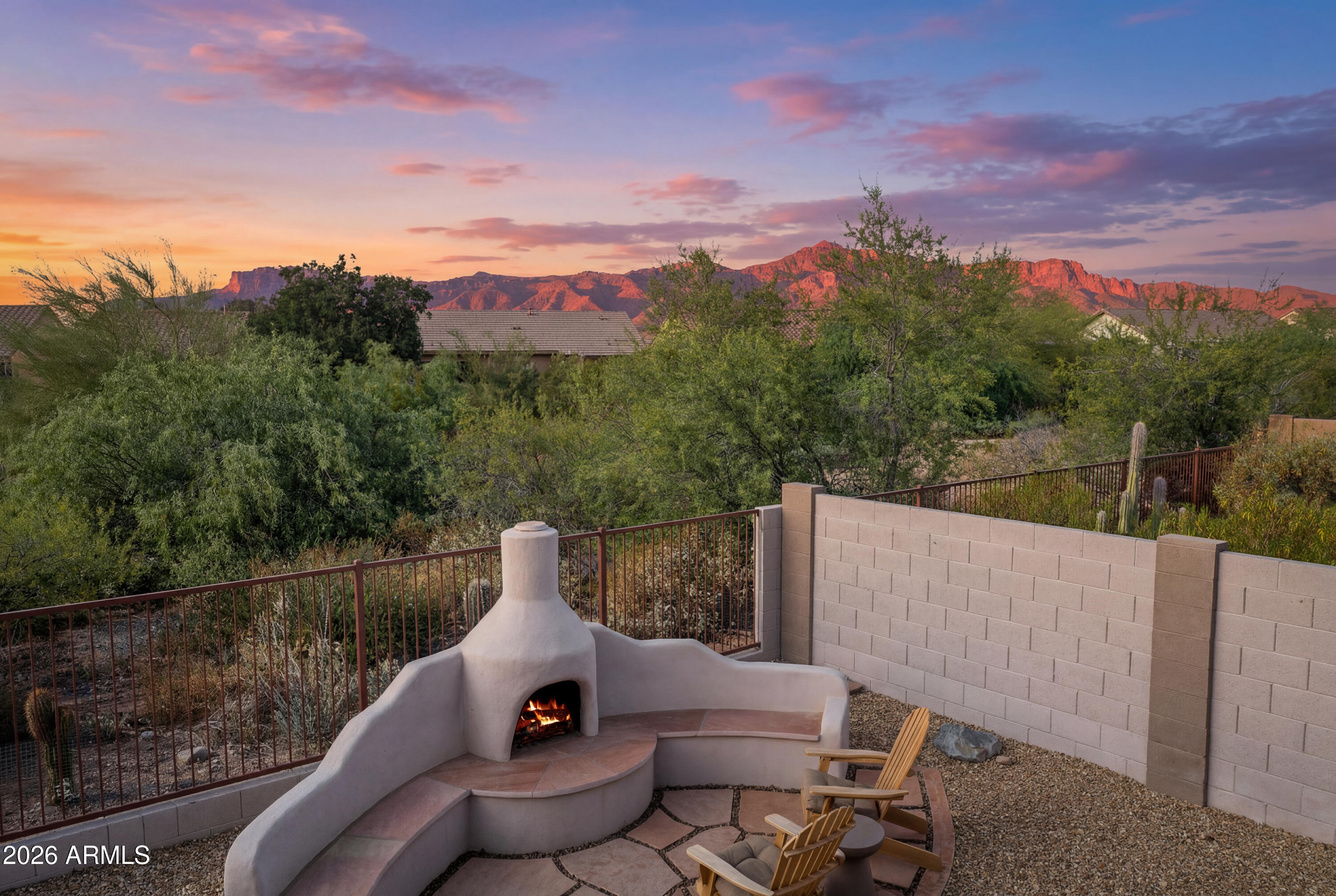 WOW!  ***TASTEFULLY UPDATED & FURNISHED HOME with GREAT LOCATION near Community Pool, backing to a wash with GREAT SUPERSTITION MOUNTAIN VIEWS! ***You'll LOVE the FULLY UPDATED KITCHEN with New Cabinets, Quartz Counters, Stainless Appliances & Recessed Lighting, Lighting, C Fans, BARN DOOR & Gorgeous luxury vinyl flooring (LVT) throughout, except in the bedroom with newer carpet & More!  You'll also appreciate the curb appeal featuring convenient PAVERS along the driveway and front walkway, plus a cozy sitting area, Backyard offers an EXTENDED COVERED PATIO, Artificial Turf, flagstone walking path to an outdoor GAS KIVA FIREPLACE with built-in bench, VIEW FENCE to wash with no homes directly behind! ***This POPULAR GATED NEIGHBORHOOD offers GREAT AMENITIES including COMMUNITY POOL and ... Clubhouse with Fitness Center too!  HOA FEE also includes Garbage Service! ***Conveniently Located, close to WORLD CLASS HIKING and Gold Canyon Golf Resort, which offers two 18-hole Championship golf courses (Dinosaur Mountain and Sidewinder) and Expansive PATIO DINING with amazing golf and mountain views! ***Nature lovers will ENJOY the nearby 2.9 million acres of Tonto National Forest wilderness, hiking, off-road trails plus four beautiful, pristine lakes too! Conveniently located just 35 minutes from Sky Harbor Airport and 20 minutes from Mesa Gateway Airport and San Tan Village Shopping & Dining! ***You'll LOVE the GOLD CANYON LIFESTYLE!
