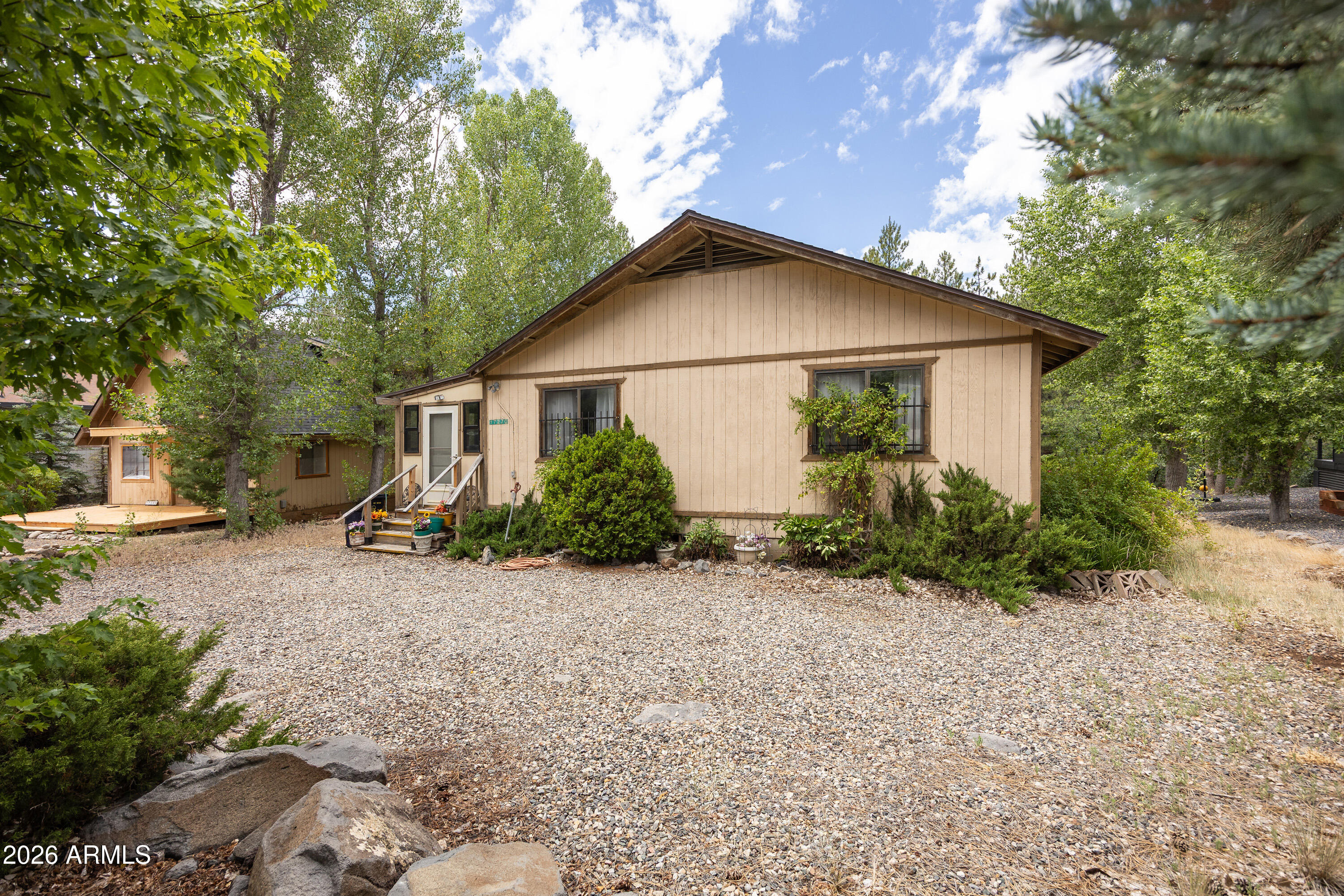 Don't miss this opportunity to own a spacious home on a 12,900 sq ft. large lot overlooking the canyon in the cool pines of Munds Park! This 2-bedroom, 2-bath home offers oversized bedrooms, two walk-in closets, two cozy fireplaces, a screened-in porch, and a versatile bonus room perfect for a home office, hobby room, or additional living space. Additional features include a separate dining area and an 8' x 10' Tuff Shed with electricity for extra storage or a workshop.

Whether you're looking for a full-time residence, a seasonal mountain retreat, or an investment property with excellent rental potential, this home checks all the boxes. Ideally located within walking distance of Pinewood Country Club and Lake O'Dell, you'll have easy access to hiking and biking trails, ATV/UTV trails, tennis and pickleball courts, playgrounds, restaurants, and the surrounding Coconino National Forest. Experience the beauty and tranquility of mountain living and discover why so many people consider Munds Park their favorite escape from the desert heat.  Come see your new home in our neck of the woods!