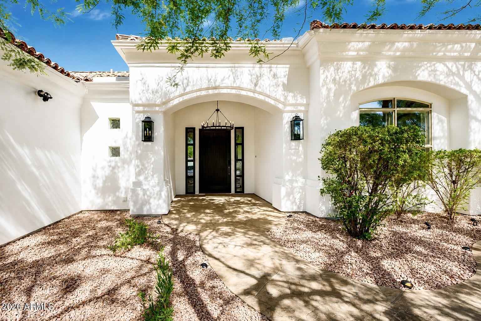 Straight out of a luxury design magazine, this extensively reimagined custom residence blends refined modern elegance with timeless warmth in the exclusive gated community of La Glorieta. Set on an oversized lot surrounded by mature landscaping and distinctive custom homes, the property offers exceptional privacy, sophistication, and character in one of Chandler's most coveted hidden gem neighborhoods. Thoughtfully curated by a high-end interior designer, the home showcases a stunning chef's kitchen featuring premium stone quartz countertops, custom cabinetry, designer lighting, and a beautifully open layout designed for both elevated entertaining and comfortable everyday living. Expansive new sliding glass doors flood the interior with natural light while creating a seamless connection to the outdoor living spaces.

The residence is further enhanced with spa-inspired bathrooms, premium hardwood flooring, elevated designer finishes throughout, and a Tesla EV charger conveniently installed in the garage. Additional major improvements include a roof replacement completed approximately five years ago and two AC units currently under manufacturer warranty, offering both style and peace of mind.

Residents of La Glorieta enjoy access to private community amenities including tennis, pickleball, basketball, and racquetball courts, all ideally located near Dignity Health Chandler, Loop 101, Loop 202, Scottsdale, Tempe, premier dining, luxury shopping, golf, and entertainment.

Fair warning: once friends and family see this home, they may suddenly find more reasons to visit.