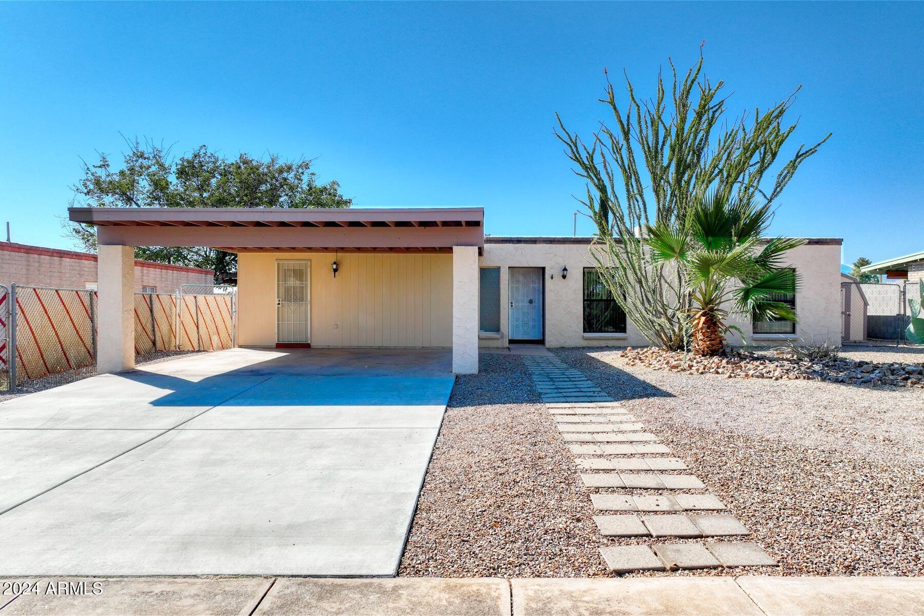 Welcome to this beautiful 4-bedroom, 2-bath home with 1,545 square feet of open-concept living. Enjoy cozy evenings by the fireplace in the spacious living area, seamlessly flowing into the kitchen. The hard surface flooring throughout makes for easy maintenance, while the huge pantry provides ample storage. Convenience is key with a washer and dryer included. Step outside to the large covered patio, perfect for entertaining or relaxing in the low-maintenance landscape. This home is ideally located near schools and shopping, making it perfect for families or anyone seeking comfort and convenience. This won't last long!