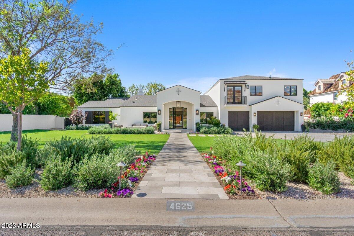 Nestled on the esteemed Exeter Blvd, in the heart of the exclusive Arcadia neighborhood, this contemporary Santa Barbara influenced home is a masterpiece crafted and constructed by Rafterhouse. Commanding attention from the street, the residence sets the stage for an extraordinary experience upon entry.
Step through the custom iron and glass front door at the formal entry, and a breathtaking view of Camelback Mountain unfolds before you. The great room, a harmonious blend of elegance and comfort, boasts multiple seating areas, a striking stone-surround fireplace, and a formal dining area featuring an impressive backlit display wall.
The main level of the split floor plan hosts the Primary Suite, offering luxurious retreat, alongside a full guest suite and an executive office. Ascend to the secondary level to discover a stunning Jr Primary Suite with a panoramic view of Camelback Mountain from both the bedroom and the picture window above the soaking tub. Two additional bedrooms and a versatile second office/den/study/play/gym complete this level, ready to adapt to your needs.
Outdoor living is equally captivating, with a front patio for intimate gatherings, featuring a custom gas fire pit and fountain. The tranquil backyard oasis accessible via large steel slider beckons with a spacious covered patio, a pool & spa surrounded by silver travertine decking, a built-in gas grill, and a bespoke pergola. Too many details to describe that must be seen in person. Extensive control 4 system with manually labeled switches throughout the home, zone HVAC control, pantera pool system with wireless controls.