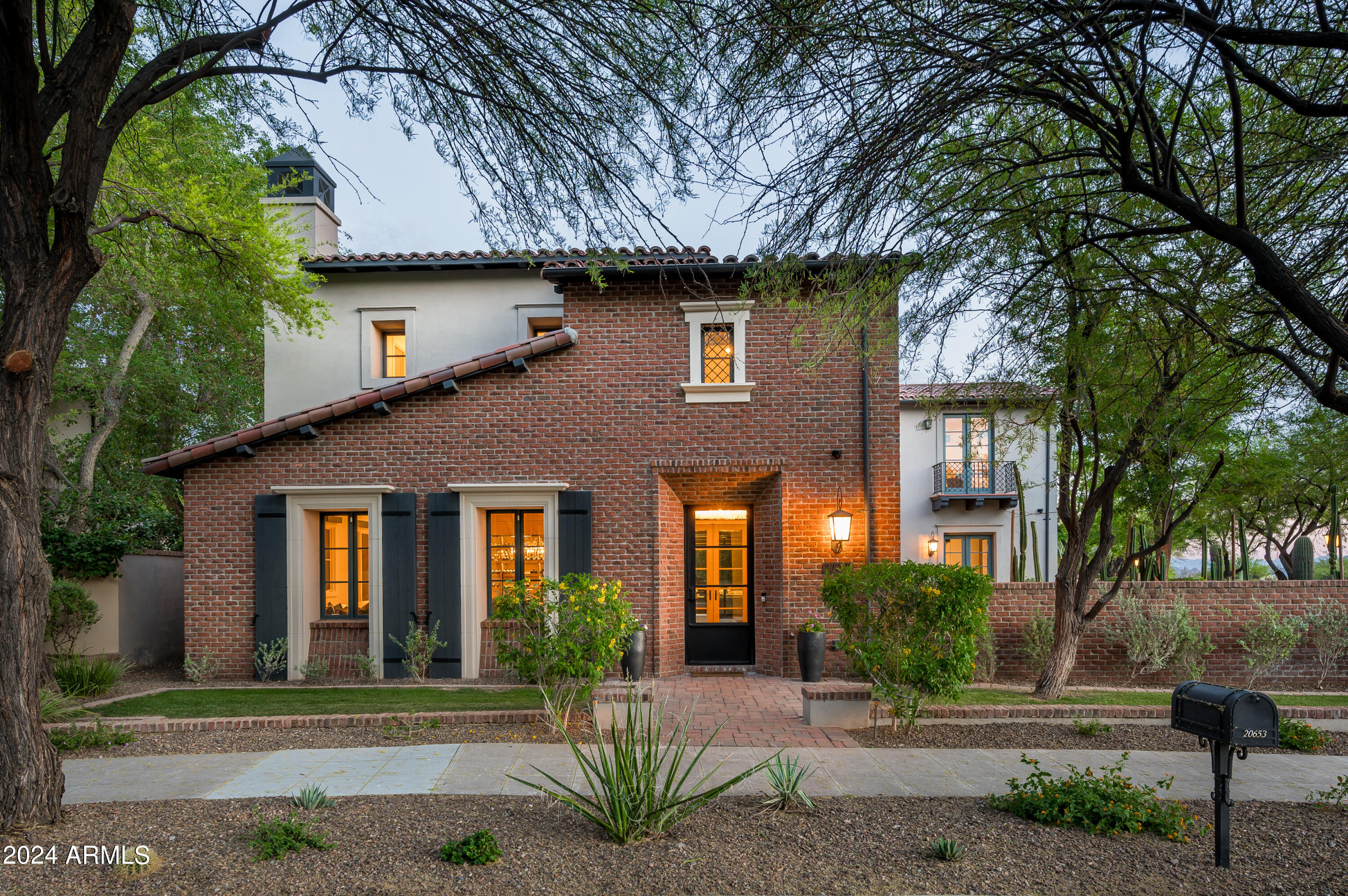 Nestled within the charming Parks neighborhood of Silverleaf, discover this exquisite Verandah home offering unparalleled luxury and privacy. Positioned on an enviable corner lot, this residence enjoys a serene setting directly across from a tranquil park, providing a picturesque backdrop for daily living. Boasting 5 bedrooms, including a flexible 5th bedroom/bonus room, alongside a den and 4.5 bathrooms, this light-filled abode offers ample space for both relaxation and entertainment. The heart of the home is the gourmet kitchen, featuring dual granite islands, Viking appliances, a butler's pantry, and a delightful breakfast room, seamlessly flowing into the spacious family room adorned with a cozy 2-way fireplace. Ascend to the primary suite, where a spacious sitting area and a dual-sided fireplace await, offering sweeping city light views to complement the luxurious ambiance. Outside, the serene outdoor living areas beckon with a glass-tiled pool, rejuvenating spa, built-in BBQ, and a gas fireplace, creating the perfect setting for gatherings and enjoying the quintessential Arizona lifestyle.
