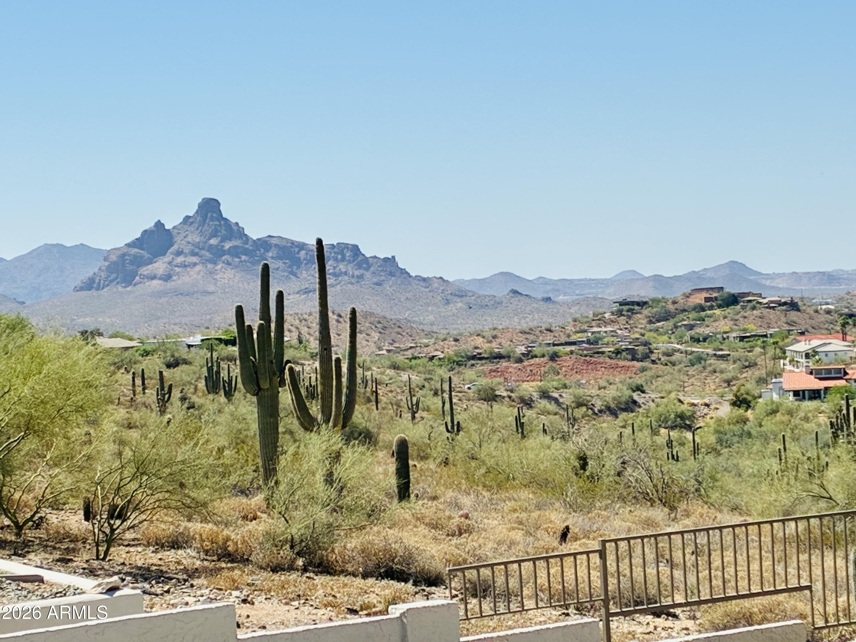 Great opportunity! Make this quality built custom home your own by updating flooring, baths & kitchen! 1st time on market. Panoramic unobstructable rear views of Red Rock & Mesa city lights! South rear patio catches the winter sun. Backs to a beautiful natural wash. Pool never in shade. Great bones w updated roof (tile in 2017 & flat in 2023) , HVAC (2011 & 2021), resurfaced pool (2014), new pump & sand filter (2015) & vacuum (2026), water heater (2023) & ext paint (2023). Dramatic wooden cupola in spacious vaulted living rm. Large efficient galley kit conveniently located between living room & a 567 SF family room addition (included in the 2308 SF total). Large open dining area between kit and living rm. Great for entertaining. Quiet location w quick & easy access to Shea. In the NPOA