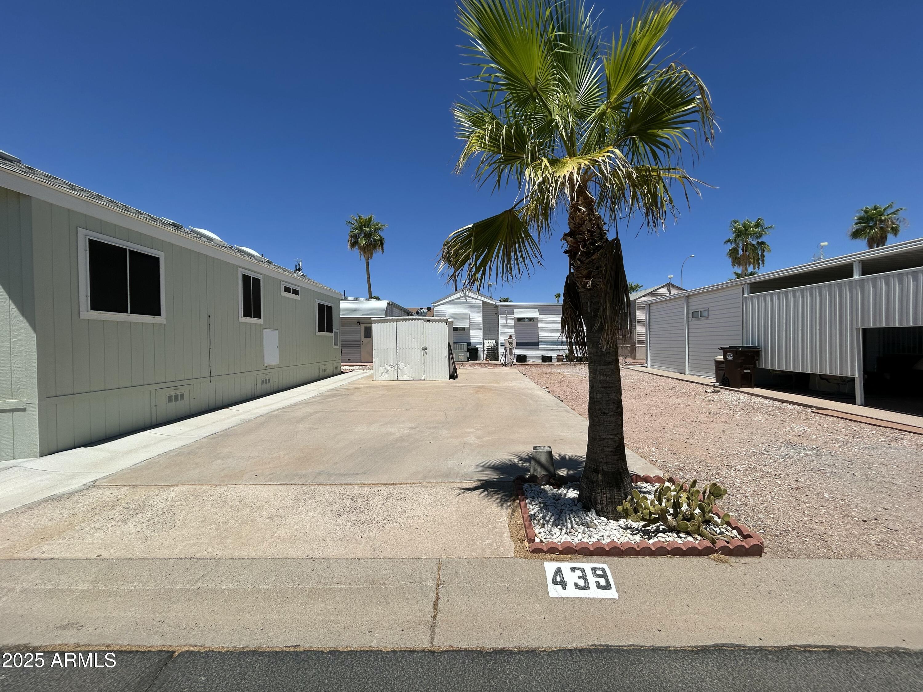 GOLDEN VISTA 55+ RESORT LIVING - YOU OWN THE LAND! Enjoy the Arizona sunshine in one of the most desirable active adult communities around - Golden Vista Resort, where you own your lot and the lifestyle that comes with it! This fantastic RV lot is ready for your arrival with all the hookups and space for a 21 ft. minimum up to 40 ft. maximum RV or travel trailer. The property includes a well-designed shed featuring a full-size washer & dryer, built-in workbench, and convenient pull-out drawers for all your tools and storage needs. Finished interior walls in the shed add a clean, organized touch. The spacious lot offers ample room for your outdoor furniture and entertaining needs. Are you looking for that ideal build site?- this is it...bring a new park model in and grab a permanent setup. Located in a premium resort location, this lot is ready for you to pull in, hook up, and start enjoying everything Golden Vista has to offerheated pools, fitness center, pickleball, clubs, and more.