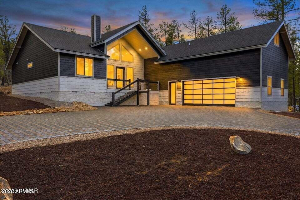 Located within the new luxury gated community of The Preserve, step into true mountain grandeur with this stunning new build designed to impress from the moment you arrive. A grand circular pavered driveway sets the tone, creating a breathtaking approach to this modern mountain retreat. Inside, the great room features soaring vaulted ceilings and tall windows that flood the space with natural light while capturing a timeless cabin in the pines feel. A striking gas fireplace anchors the room, offering both warmth and a dramatic focal point. The kitchen is equally impressive with quartz countertops, stainless steel appliances, and a layout perfect for entertaining and everyday living. The spacious primary suite is a private retreat, complete with dual vanity sinks.