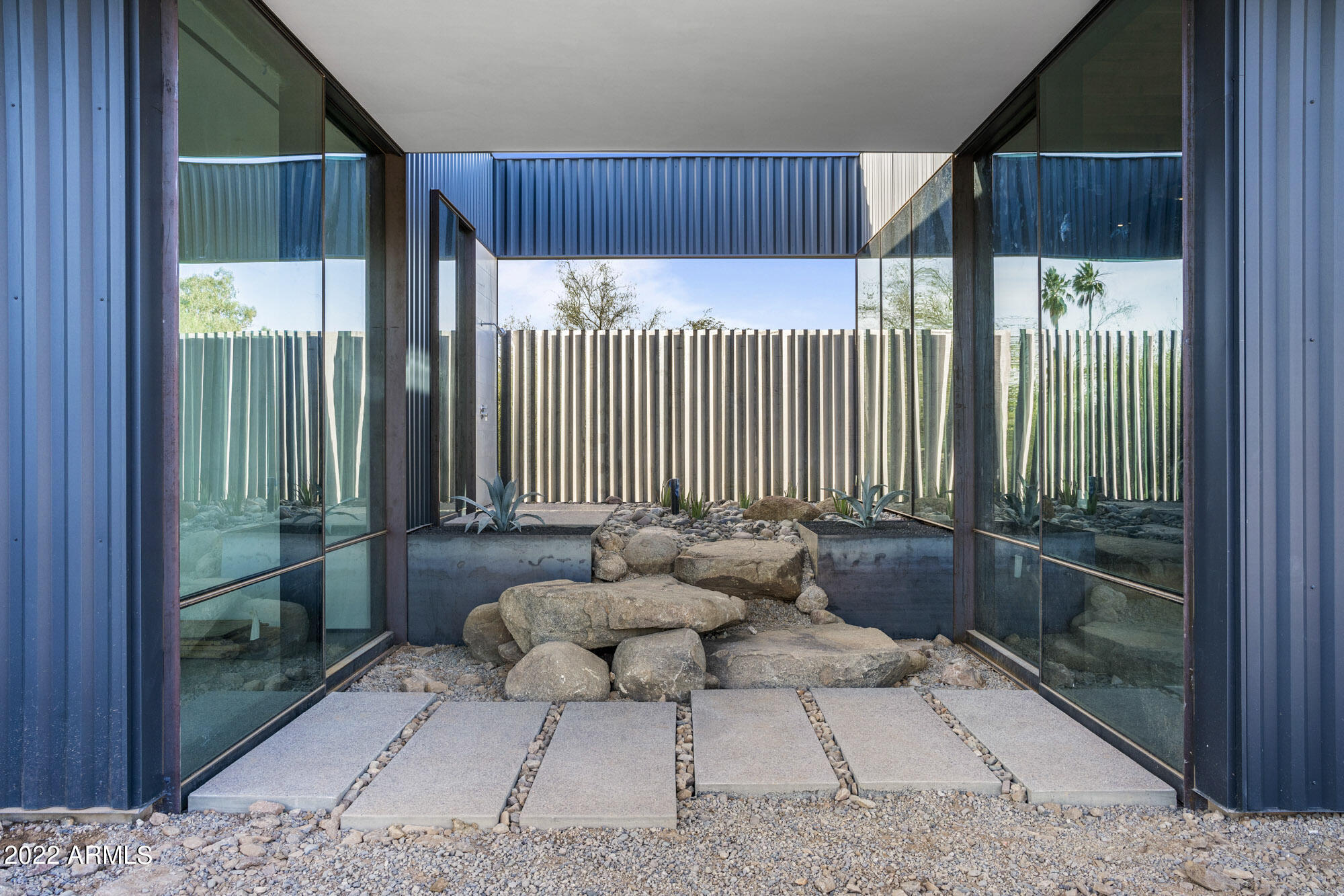 Modern home design/build by The Construction Zone with vertical board formed concrete and custom metal siding.
Home is under construction.