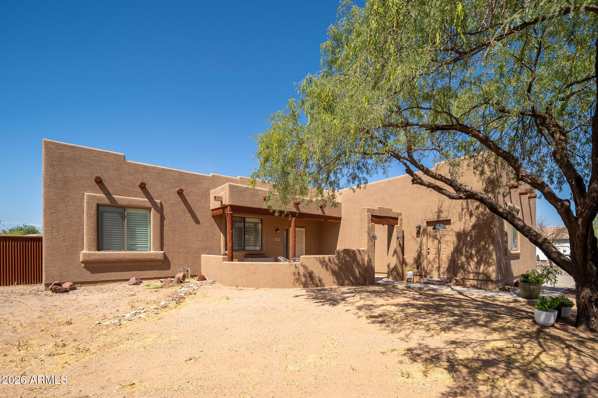 Beautifully upgraded property on 1.25 acres with NO HOA and FULL DETACHED SHOP AND CASITA. This one has it all!  Fully remodeled 1811 sqft 3 bed, 2 bath, plus a separate office with its own private entry.  Enter into the fully fenced and electronically gated backyard to find a detached 560 sq ft fully remodeled casita featuring a full kitchen, full bathroom, and stacked washer/dryer.  Ideal for guests, multigenerational living, or rental income. The property also includes an impressive 1,886 sq ft detached RV garage with two 12'x12' roll-up doors, AC, water, and 220 amp power. In addition to all these extras the home has a 3 year old roof and upgraded AC units.  This one is move in ready so bring your toys, your animals, and your friends!!